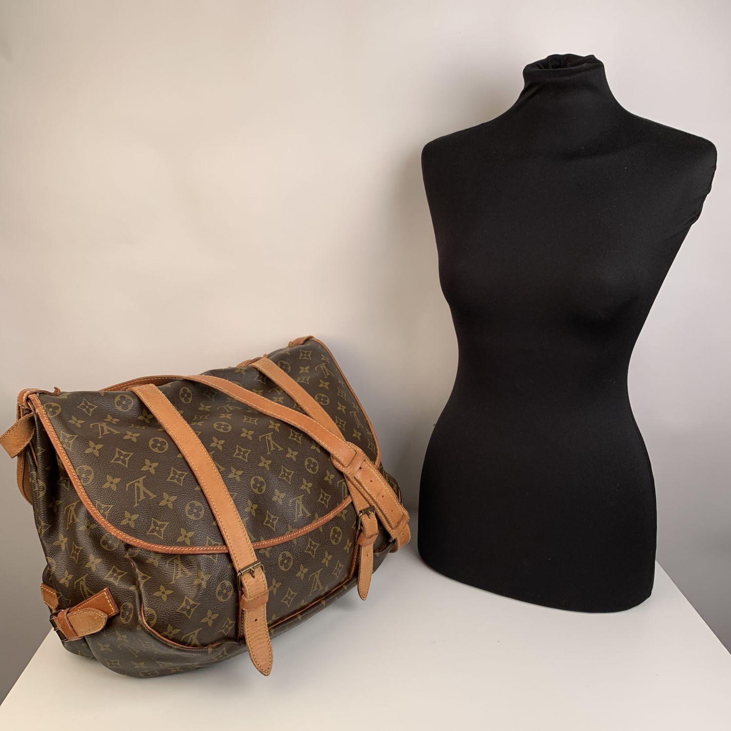 Rare Louis Vuitton Saumur 40 Messenger Bag. The largest model of the Saumur line. Discontinued model, very collectible. Inspired by equestrian 'SADDLE' bag, the legendry SAUMUR 40 features dual front compartments, held tightly together at the sides