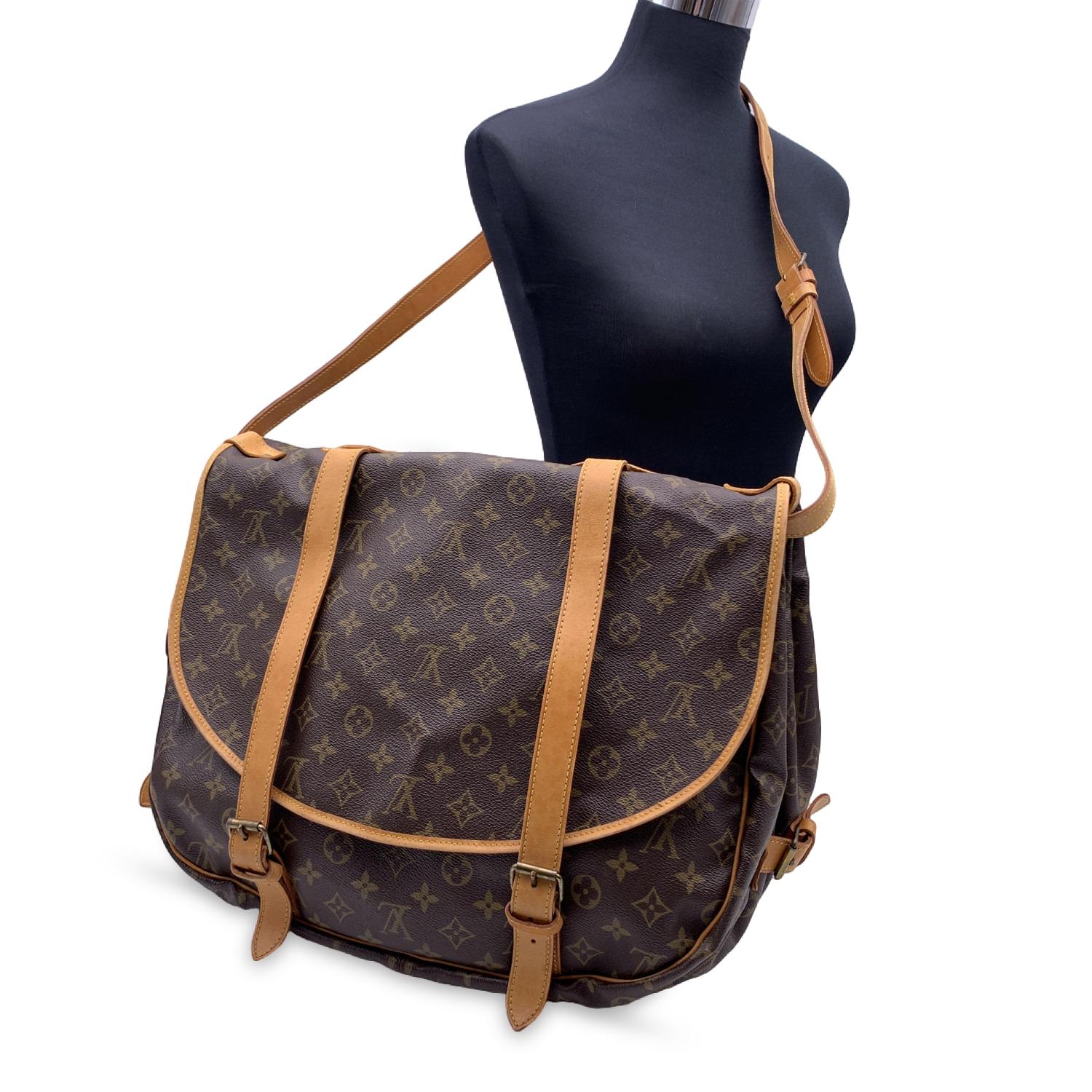 Rare Louis Vuitton Saumur 40 Messenger Bag. The largest model of the Saumur line. Discontinued model, very collectible. Inspired by equestrian 'SADDLE' bag, the legendry SAUMUR 40 features dual front compartments, held tightly together at the sides