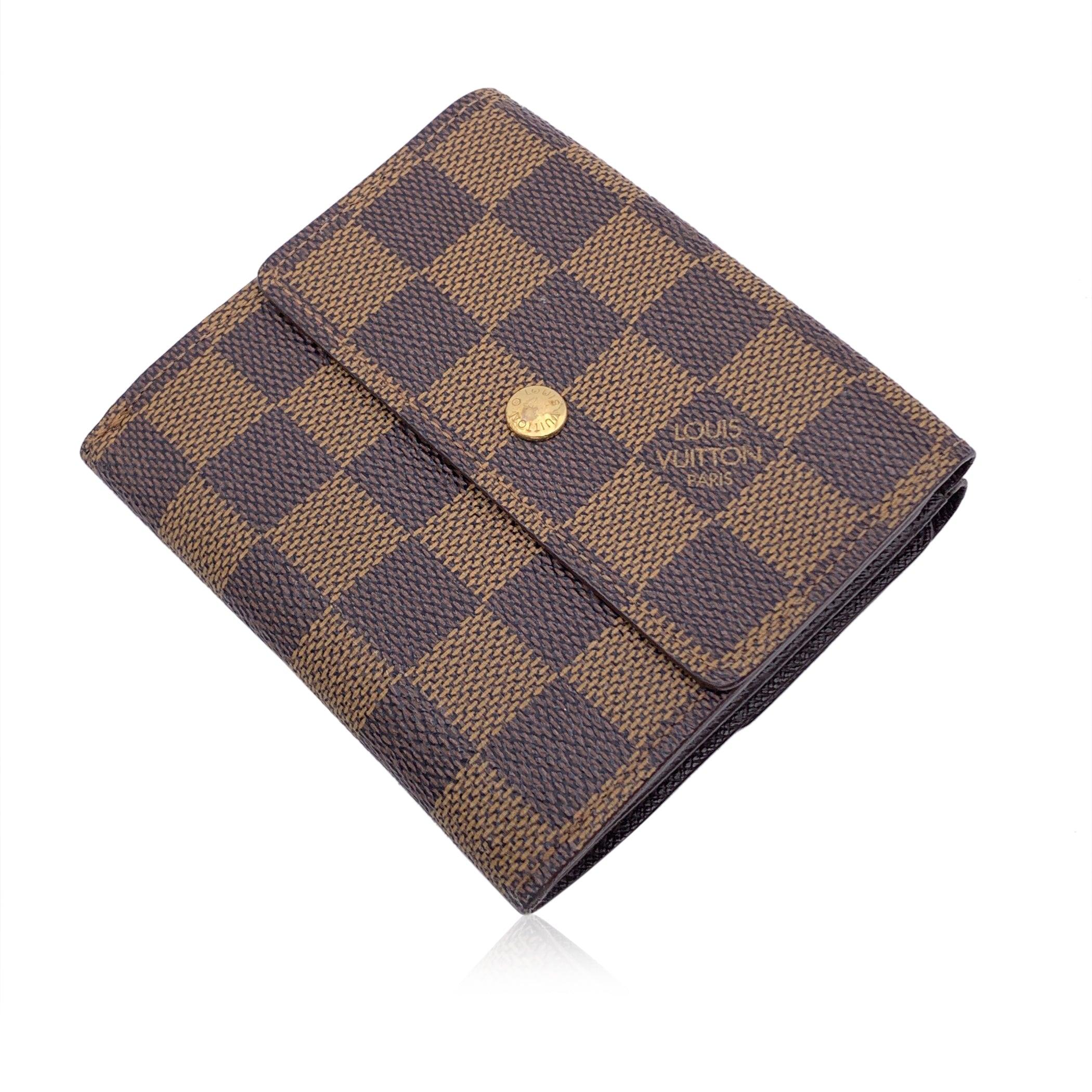 Louis Vuitton 'Elise' square-shaped wallet with double side flap. . Crafted in brown Damier Ebene canvas. Brown leather lining. 1 coin compartment on a side and a bifold section on the other side, with 1 bill compartment, 4 credit card slots and 2