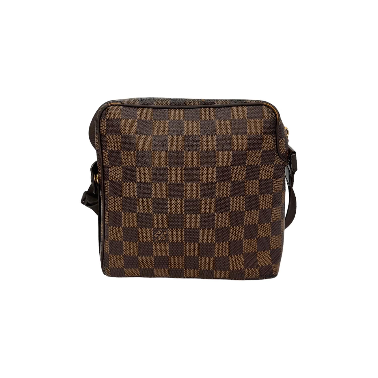 This Louis Vuitton Damier Ebene Olave PM is finely crafted of the classic Louis Vuitton Damier Ebene coated canvas with leather trimming and gold-tone hardware features. It has a flat adjustable shoulder strap. It has a frontal slip pockete. It has