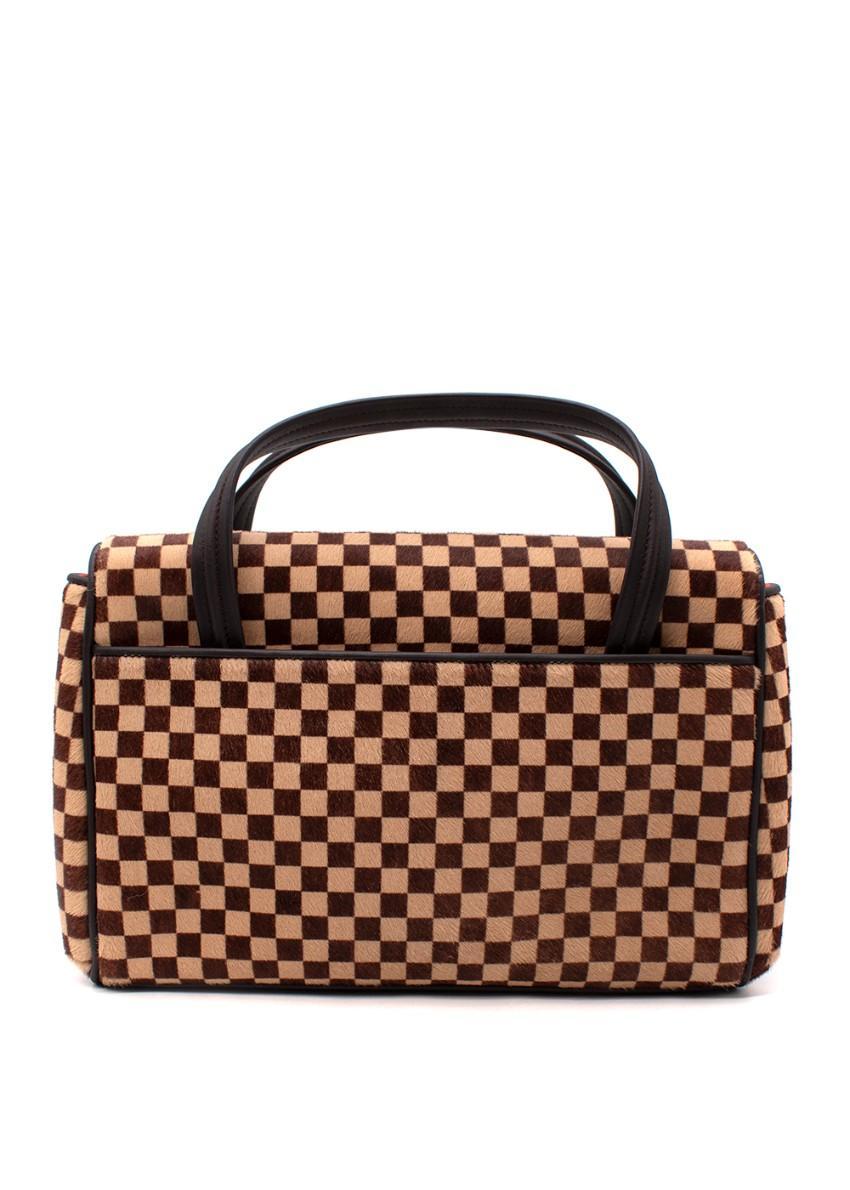 Louis Vuitton Vintage Damier Sauvage Lionne Brown Calf Hair Bag

- Limited edition, vintage piece
- Iconic Damier checkerboard print rendered in closely shaved calf hair
- Features flap and magnetic closure and 1 open slip pocket on back
- Orange