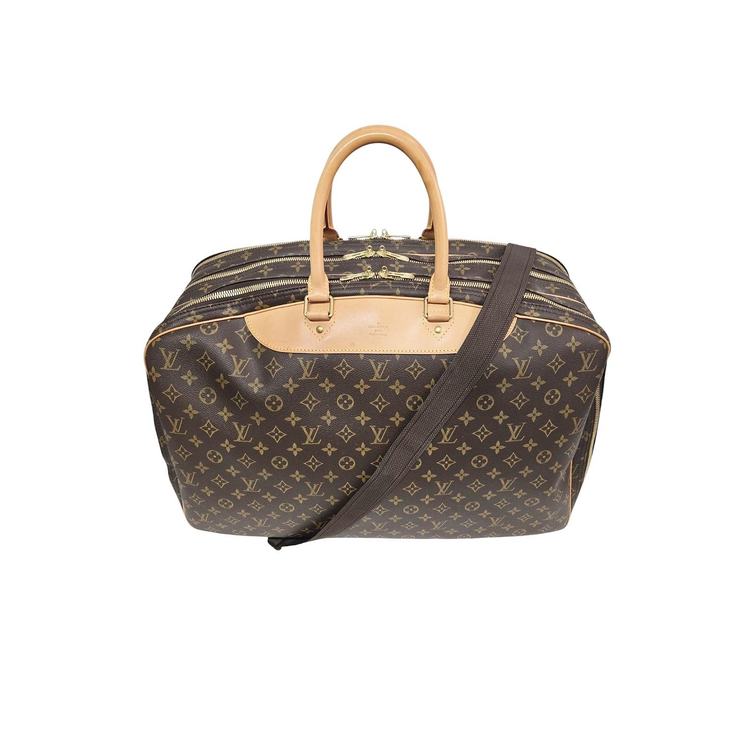 This Louis Vuitton Monogram Alize 3 Poche Soft Suitcase is crafted of Louis Vuitton monogram coated canvas in brown with vachetta leather trim. It features vachetta cowhide rolled leather top handles, an adjustable fabric shoulder strap, and brass