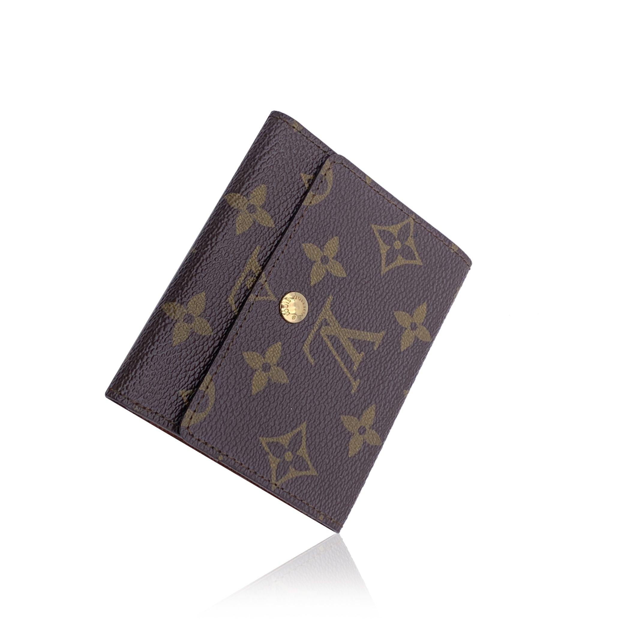 Vintage Louis Vuitton Business Card Holder Wallet . Crafted in brown monogram canvas. Flap with button closure. Tan leather lining. 2 card sections inside. 'Louis Vuitton Paris - Made in France' embossed inside. Authenticity serial number embossed