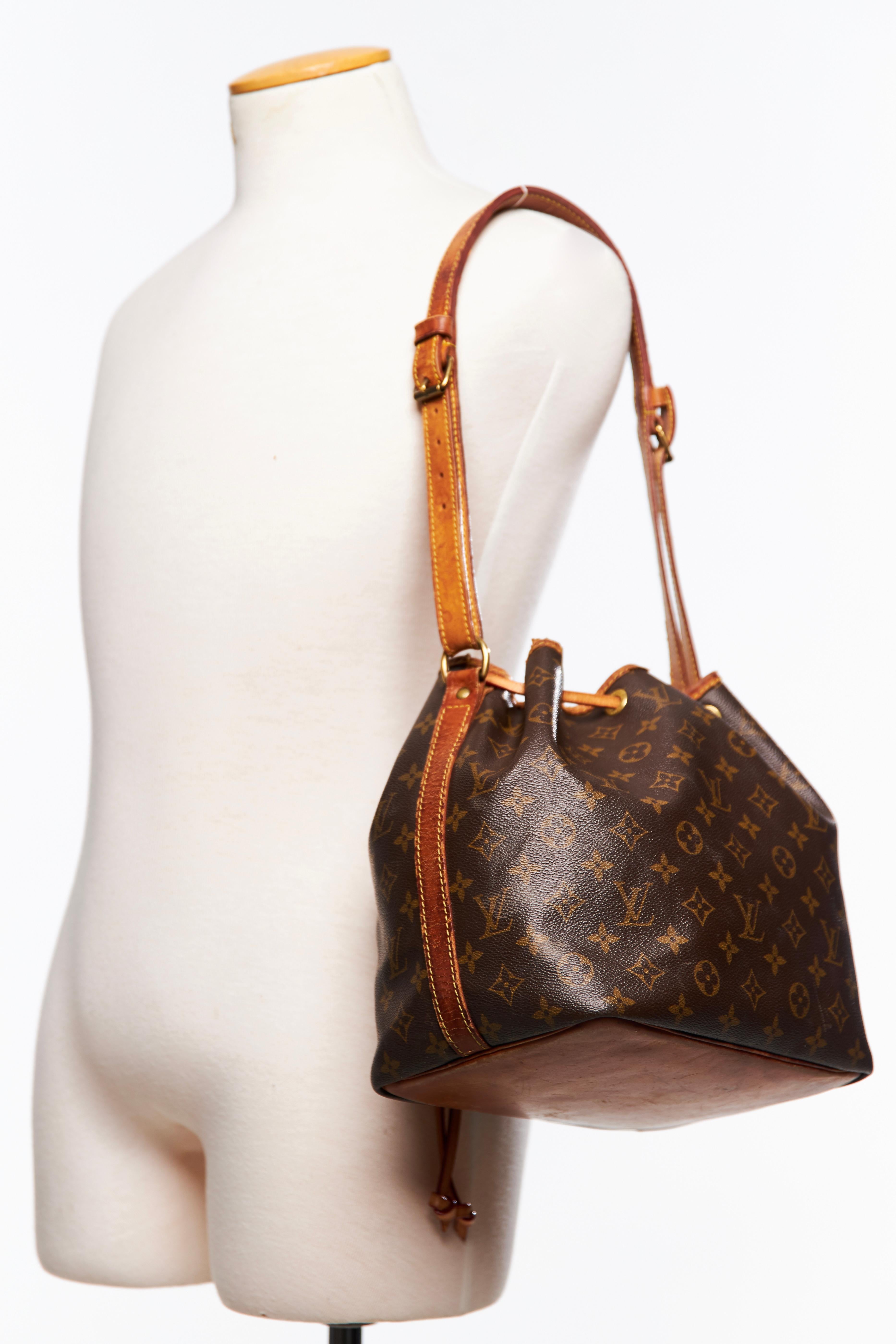 COLOR: Brown
MATERIAL: Coated canvas
DATE CODE: AR8911 
MEASURES: H 11” x L 12” x D 8”
DROP: 12”
CONDITION: Fair - scuffs, marks and stains to leather. The natural leather has darkened to a nice caramel colour due to patina. Ripping to leather