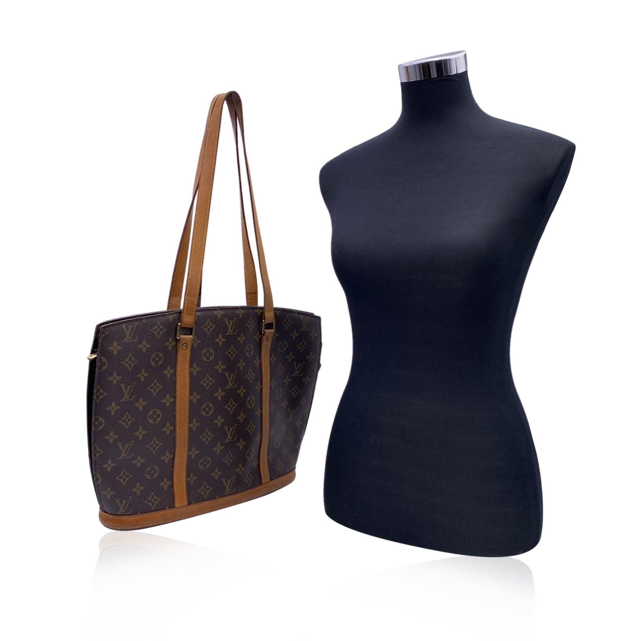 Louis Vuitton Cabas Babylone tote in timeless monogram canvas. Genuine leather trim and handles. Upper zipper closure. Beige lining. 1 side zip pocket, 1 side open pocket, D-ring ,2 pen slots inside. 'LOUIS VUITTON Paris - Made in France' engraved