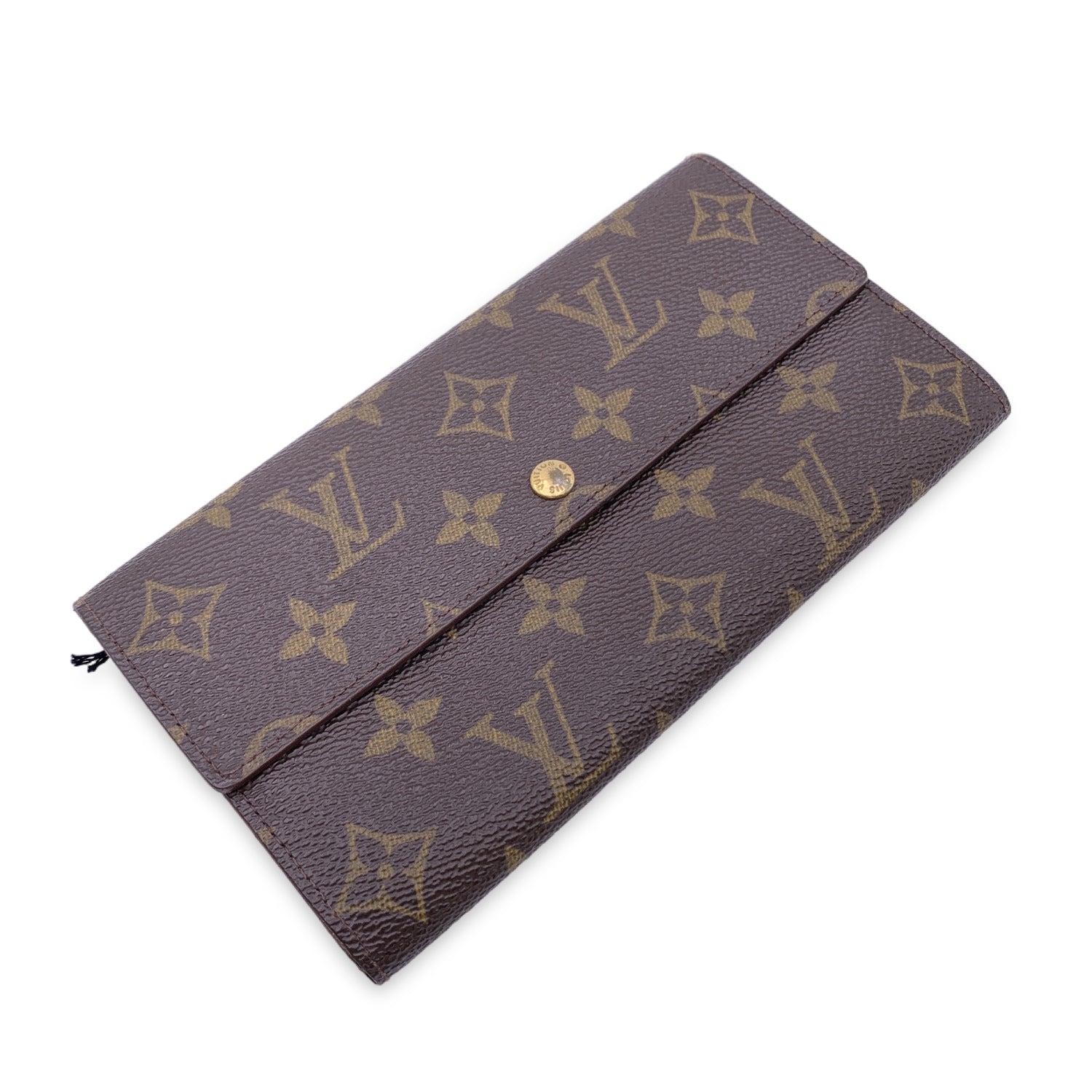 Louis Vuitton 'Sarah' wallet, in brown monogram canvas. Interior fully lined in leather. Flap with snap closure. 2 open pockets under the flap. 1 coin compartment with zip closure. 2 bill compartments. 'LOUIS VUITTON Paris - Made in France' engraved