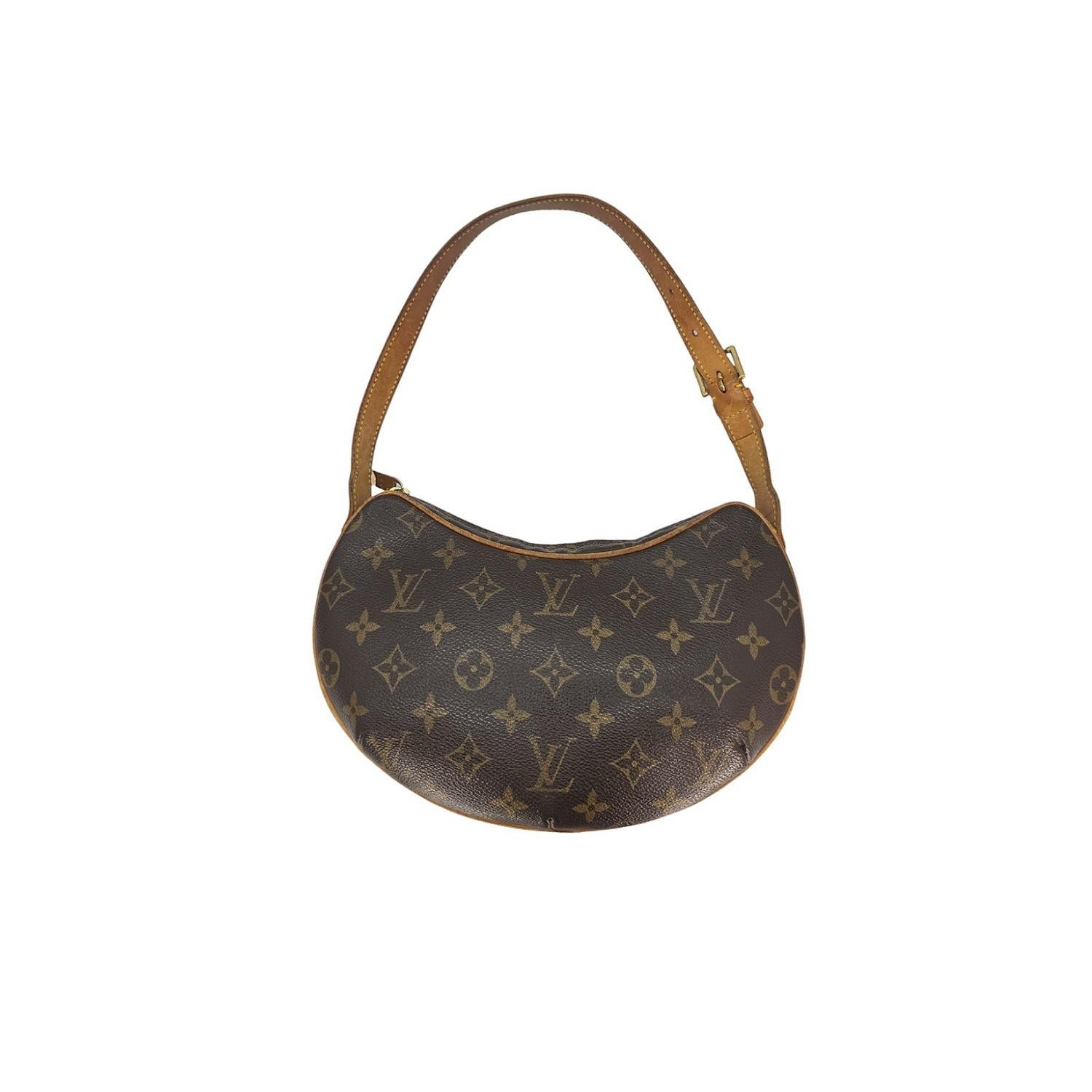 Elevate your style with this Louis Vuitton Monogram Canvas Croissant PM bag. Crafted from monogram toile canvas and natural cowhide leather, it features an adjustable shoulder strap and a spacious interior with a slip pocket. The brass top zipper
