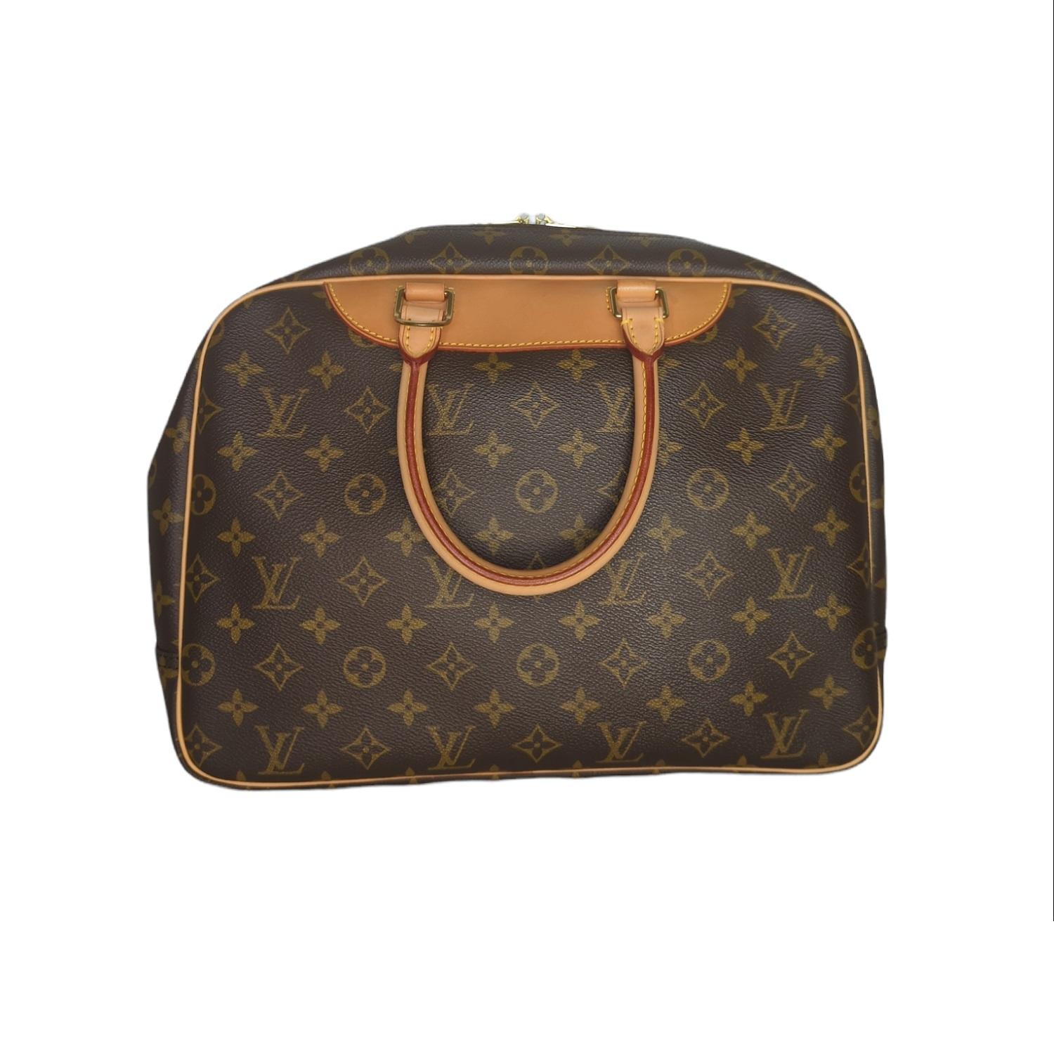 This Louis Vuitton Monogram Deauville Canvas Bowling bag, is crafted from brown and tan monogram coated canvas, features dual rolled top handles, cowhide leather trim, and brass hardware. Its two-way zip-around closure opens to a beige canvas lining