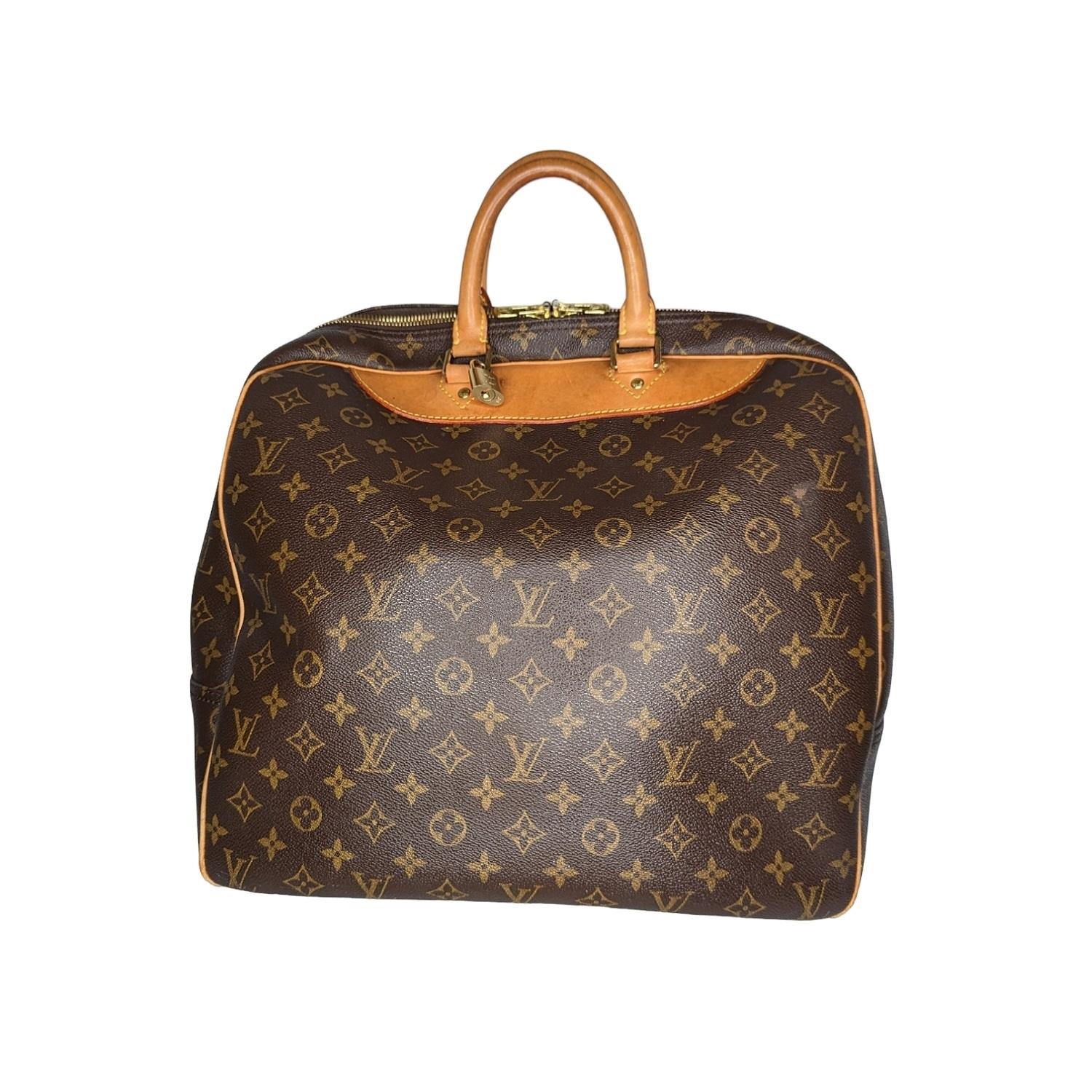 This bag is done in a traditional canvas with vachetta leather trim. The interior is done in a tan textile lining. This bag features a zip top closure and gold-tone hardware. Est. Retail $1,810.

Designer: Louis Vuitton
Material: Monogram coated