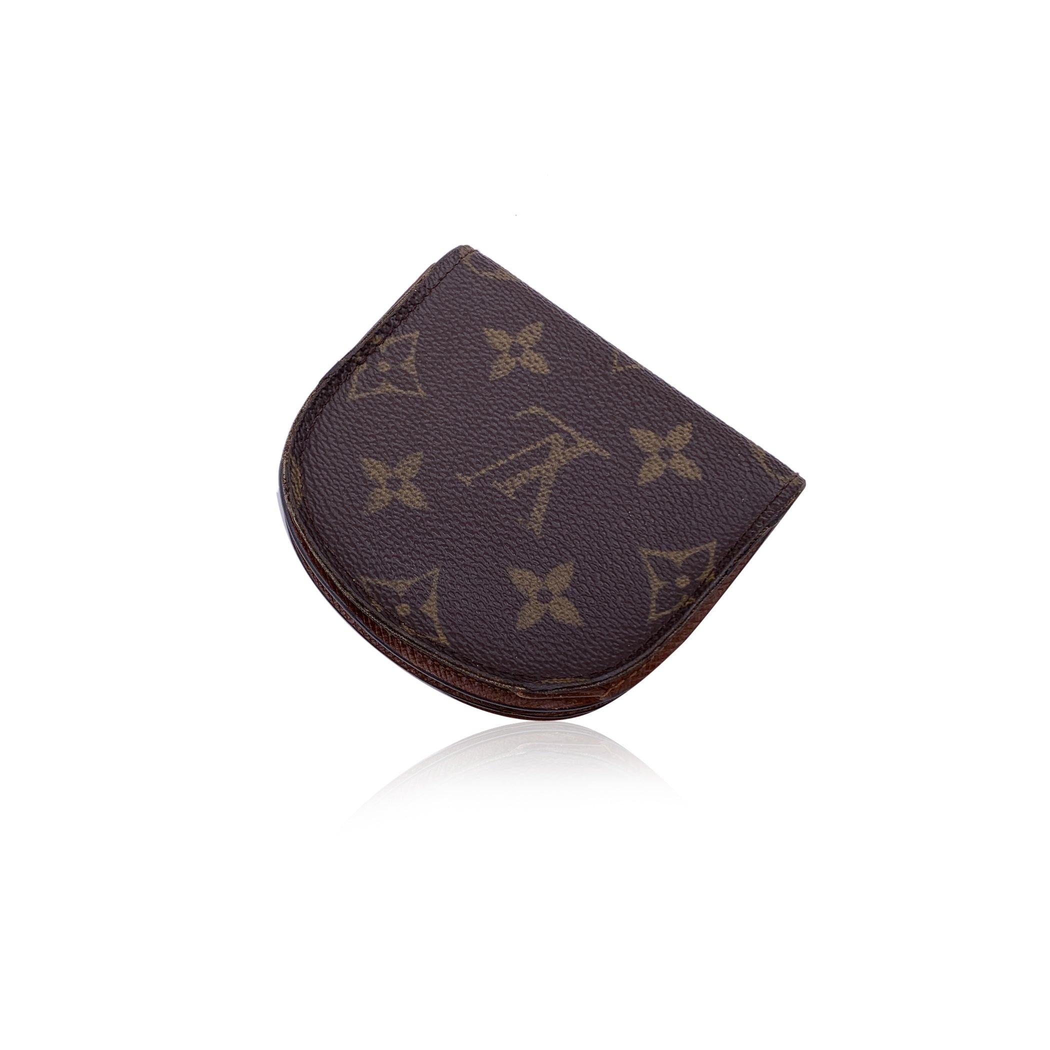 Louis Vuitton coin purse, mod. M61970. Monogram canvas. Leather lining. Flap and press stud closure. 2 compartments and 1 section with flap. 'Louis Vuitton Paris - Made in France' embossed inside. Authenticity serial number embossed inside a pocket.