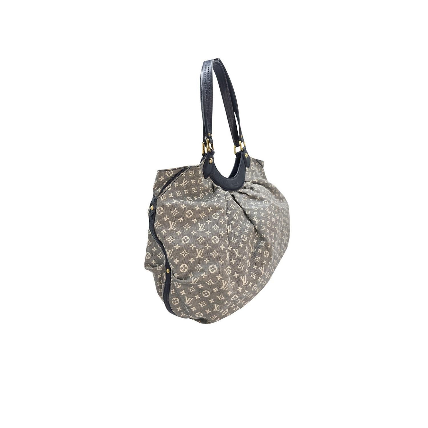 Expertly crafted by Louis Vuitton, the Monogram Canvas Idylle Fantaisie Hobo Bag is the perfect blend of style and functionality. Made with durable mini-monogram canvas and navy leather trim, this bag has a spacious navy interior with multiple