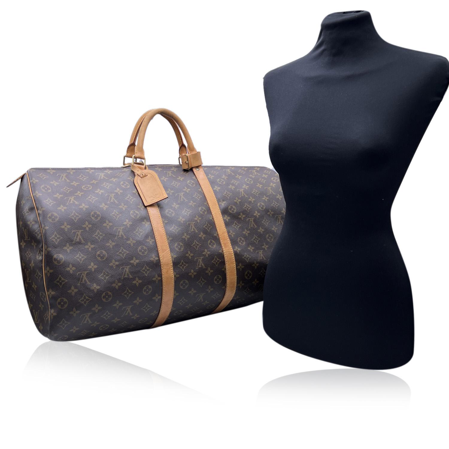 Louis Vuitton classic Monogram Canvas vintage 'Keepall 60' Travel bag. Monogram canvas, brown canvas lining, natural cowhide trim. Golden brass pieces. Double zip closure. Rounded leather handles. Removable leather ID holder. Authenticity serial