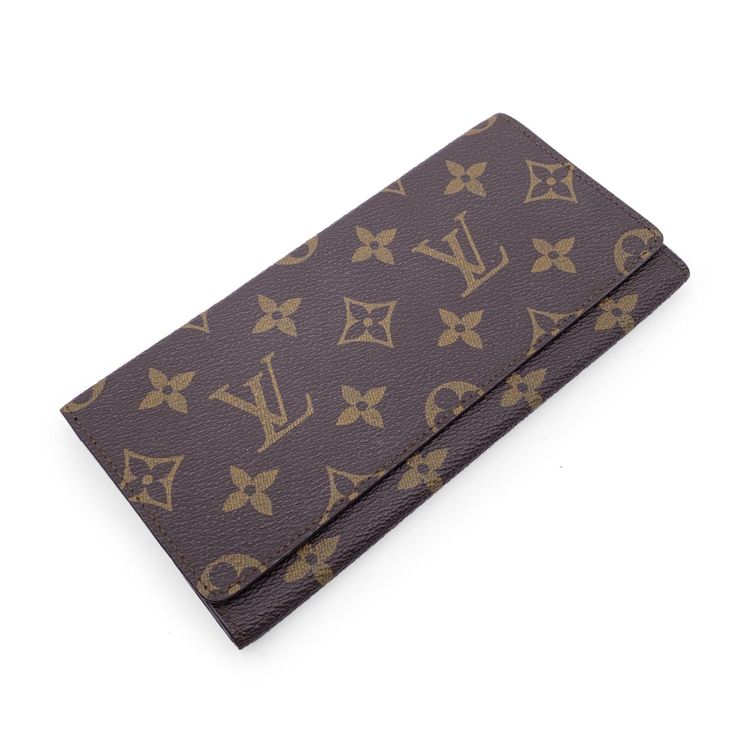Vintage Louis Vuitton brown monogram canvas Long Bifold Bill Wallet. Flap closure. Leather lining. 1 main compartments inside. 1 open pocket under the flap. 'LOUIS VUITTON Paris - made in France' engraved inside. Details MATERIAL: Cloth COLOR: Brown