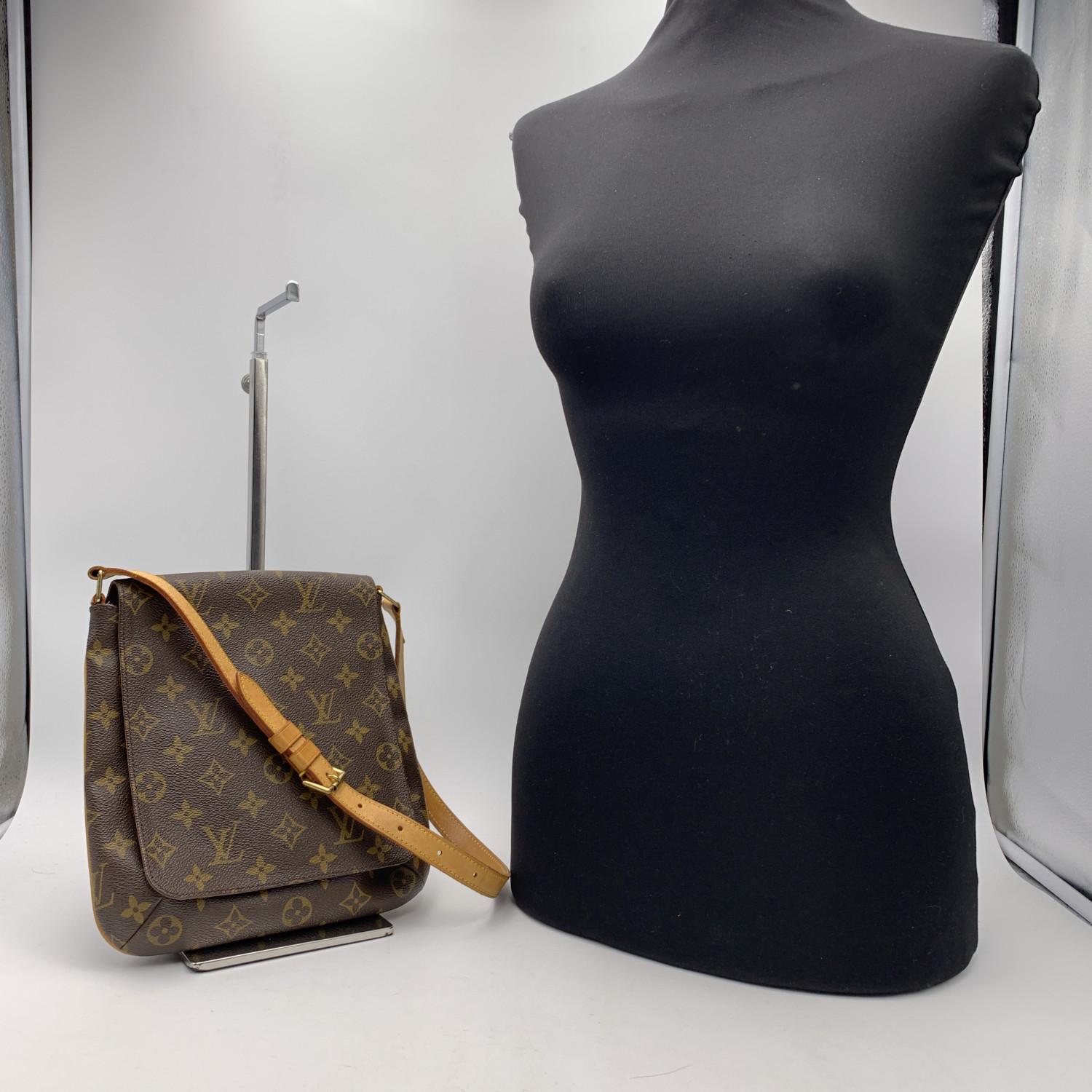 Louis Vuitton 'Musette Salsa'Shoulder Bag, crafted in timeless LV monogram canvas, the bag has golden brass hardware. The exterior features a flap with magnetic button closure. Its interior is lined with soft mustard lining and features 1 open