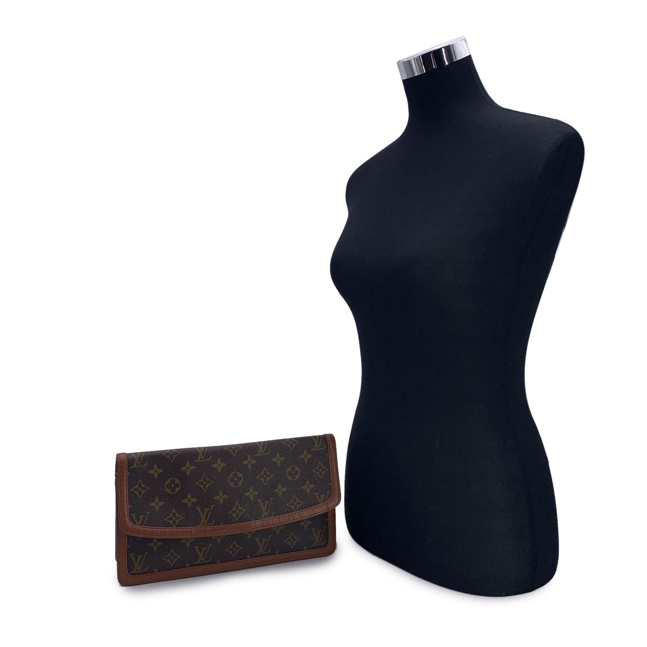 Elevate your collection with this exquisite Louis Vuitton 'Pochette Dame' clutch bag, a stunning blend of elegance and functionality. Crafted from the brand's signature brown monogram canvas, this clutch features rich brown genuine leather trim,