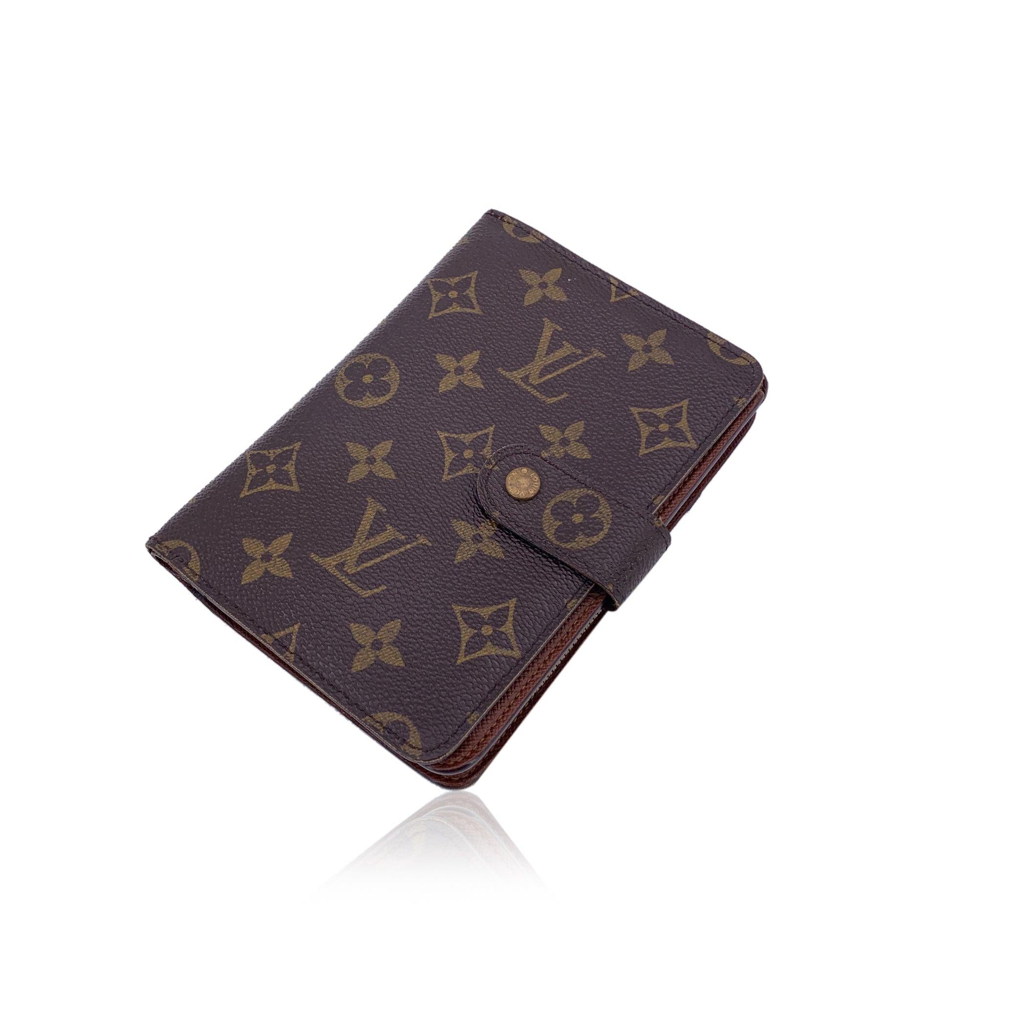 Embrace timeless Louis Vuitton elegance with this Monogram Porte Papier Zipped Wallet, a perfect blend of practicality and luxury. Crafted from the brand's signature Monogram coated canvas, this compact wallet exudes both durability and