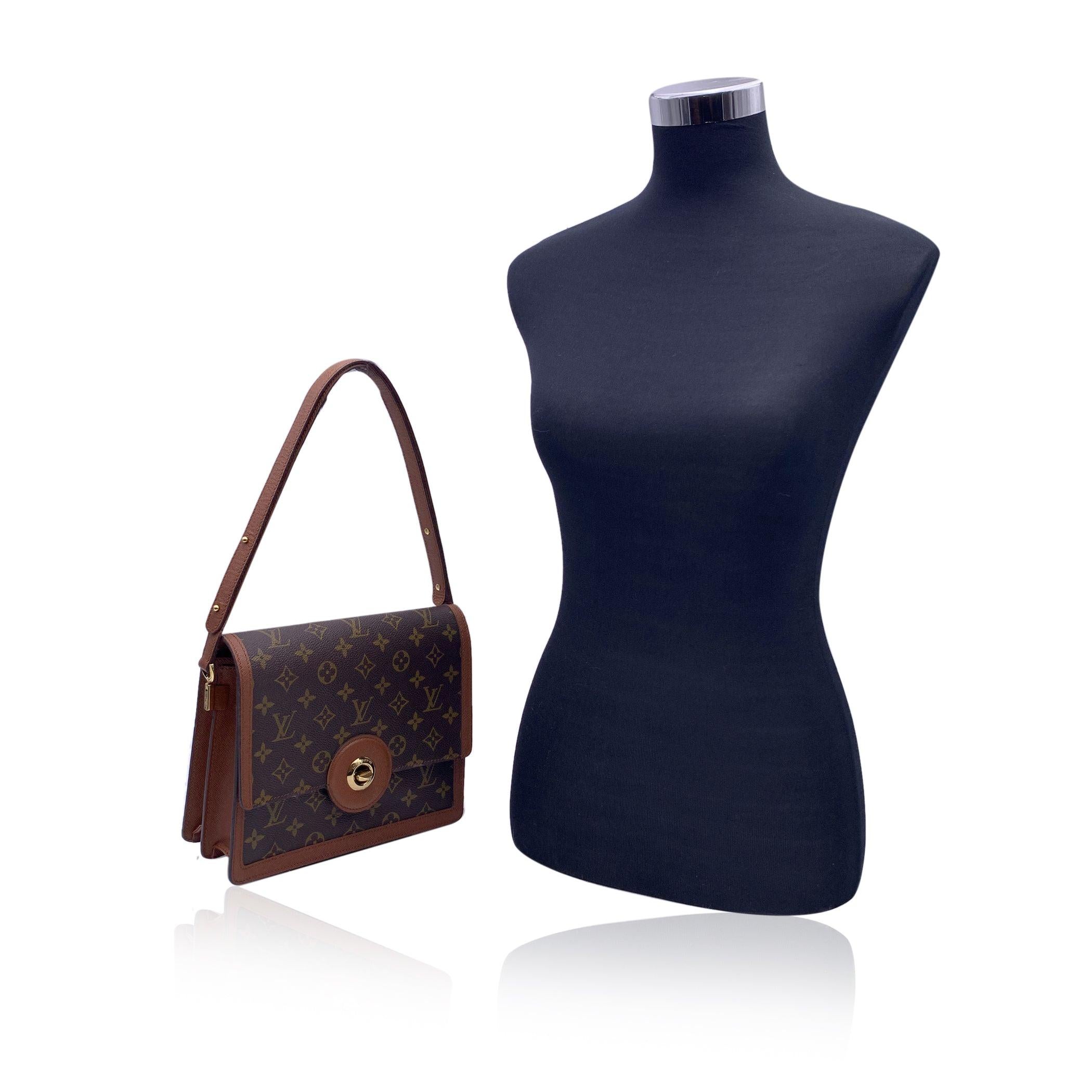 Louis Vuitton Vintage Monogram Canvas 'Raspail' Shoulder Bag. Crafted in Monogram canvas with brown genuine leather trim and shoulder strap. Adjustable leather shoulder strap. Flap gold metal signature twist closure. Interior fully lined in leather.