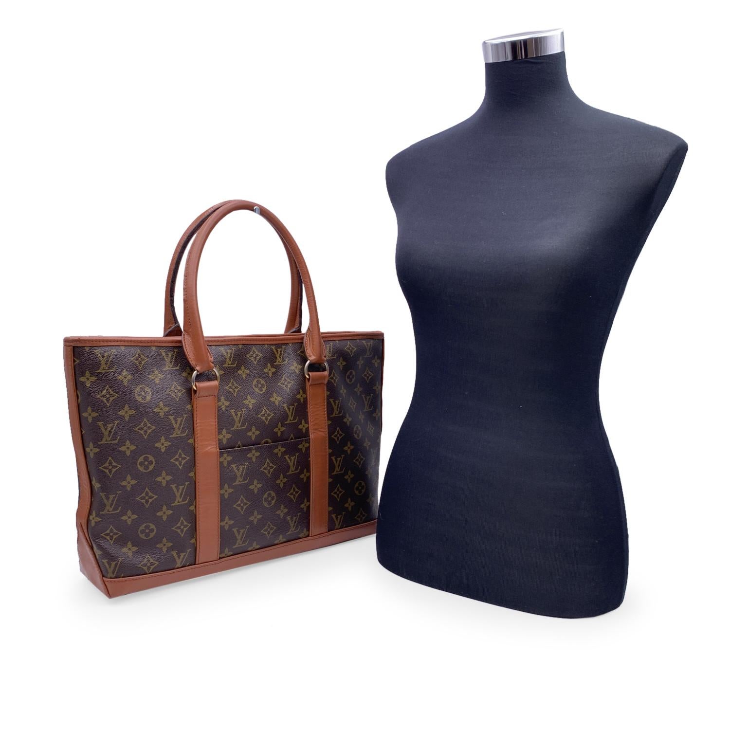 Vintage LOUIS VUITTON 'Weekend' tote bag in timeless monogram canvas with brown genuine leather trim and handles. Discontinued in the early 1990's. 1 open pocket on the front and 1 open pocket on the back. Open top. 1 inside zippered pocket and 5