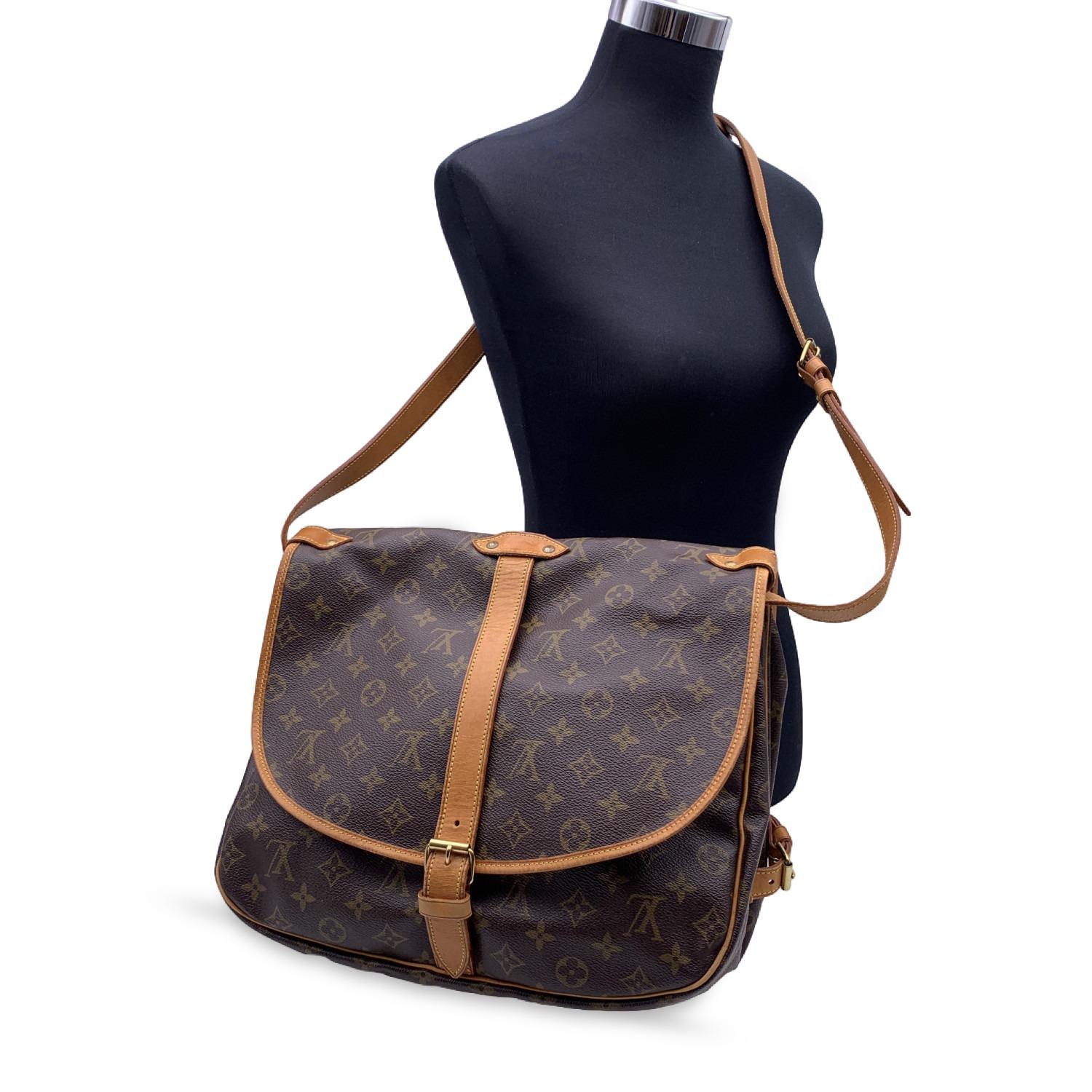 LOUIS VUITTON 'Saumur 35' inspired by equestrian 'SADDLE' bag. The legendary SAUMUR features dual front compartments, held tightly together at the sides with belt-like tabs. Adjustable long shoulder strap with pad for added comfort.

- Monogram