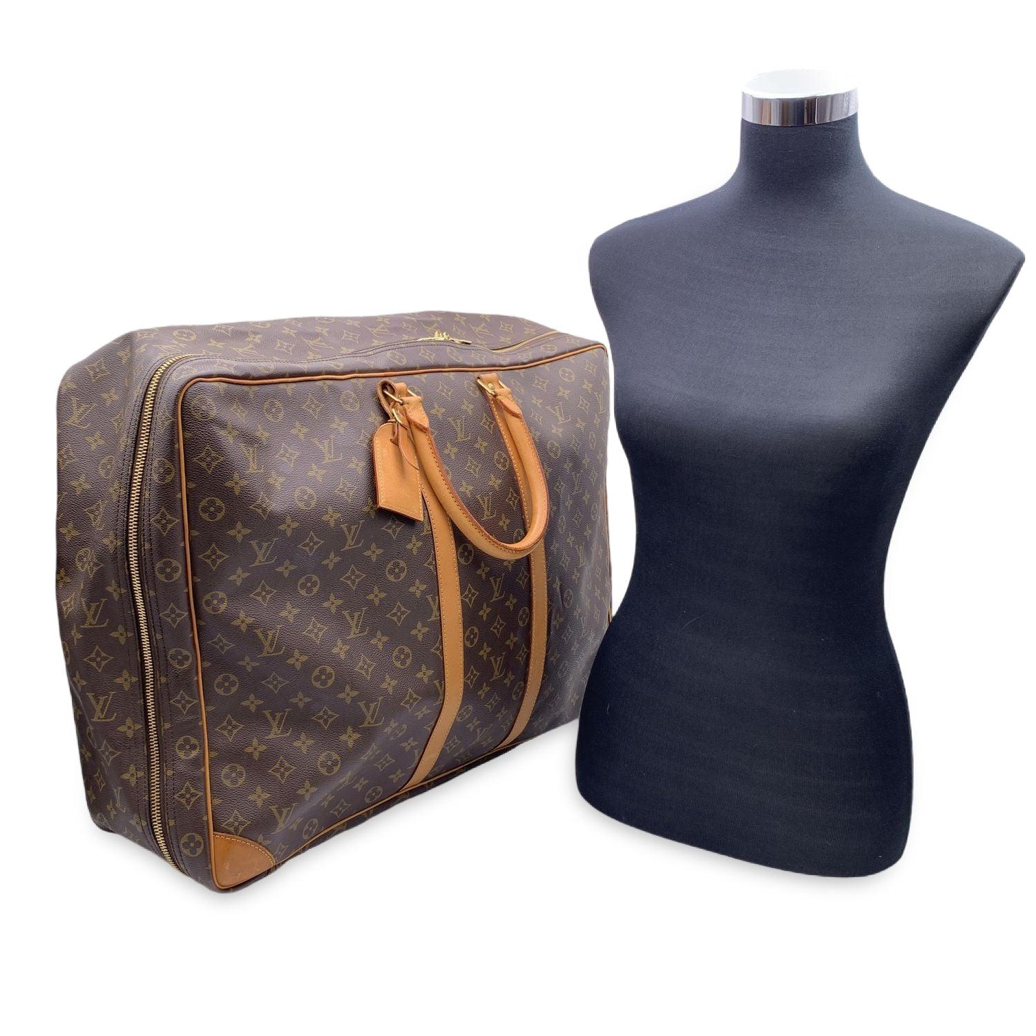 Splendid Louis Vuitton soft-sided SIRIUS 55 suitcase crafted in classic and timeless brown Monogram canvas. It features gold-tone hardware, natural cowhide leather trim and accents, double rolled leather handles and a full double zipper closure.