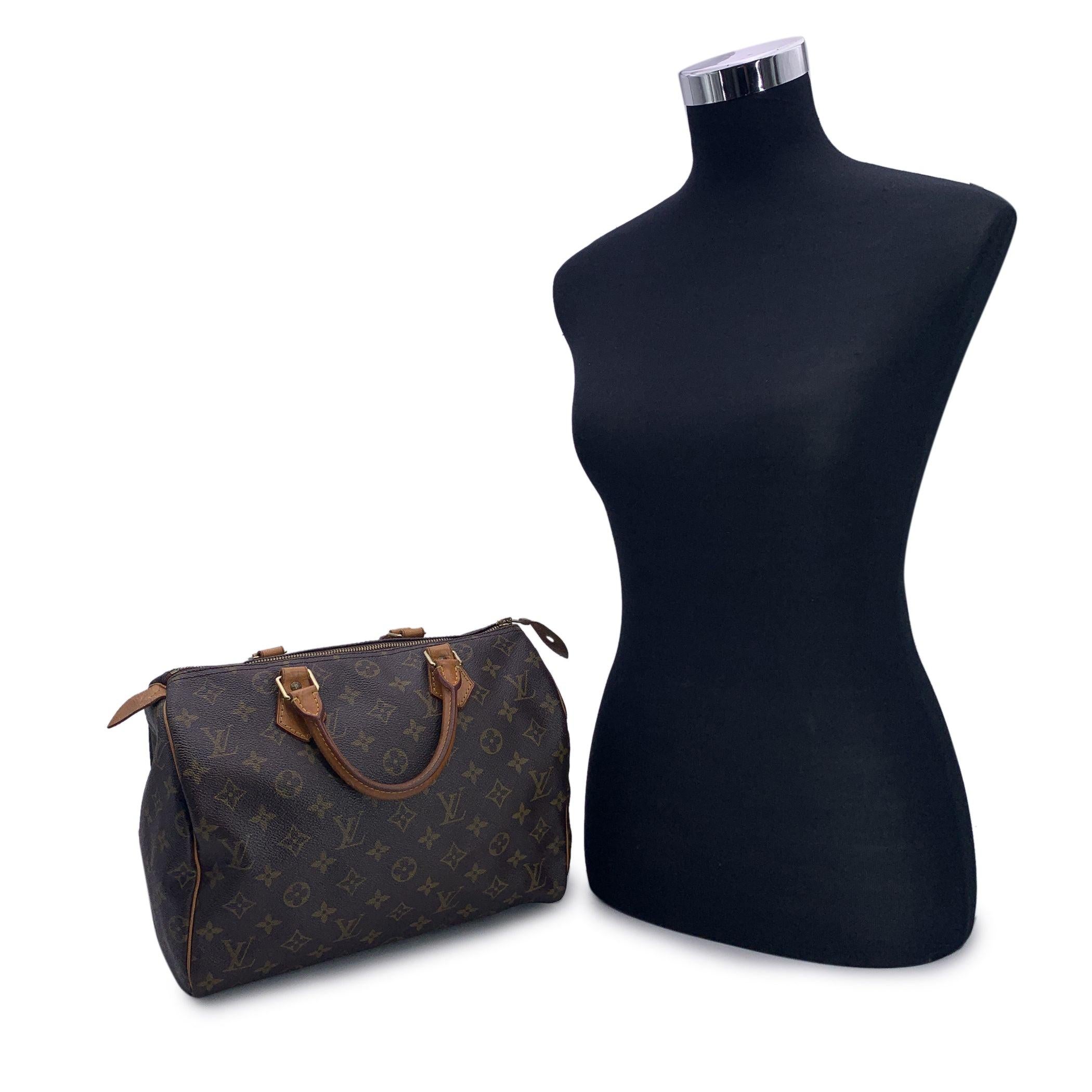 This classic Louis Vuitton SPEEDY 30, one of the most popular lines in the LV monogram. Rounded form, double leather handles and piping. Brown monogram canvas. Gold metal signed hardware. Upper zipper closure with tan leather zipper pull. Brown