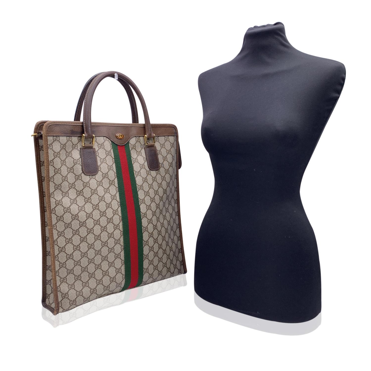 Beautiful Gucci tote made in brown monogram canvas with brown leather trim and handles. Green/Red/Green stripes on the front and on the back. Upper zipper closure. Beige lining. 1 side zip pocket inside. 'GUCCI Accessory collection - Made in Italy'