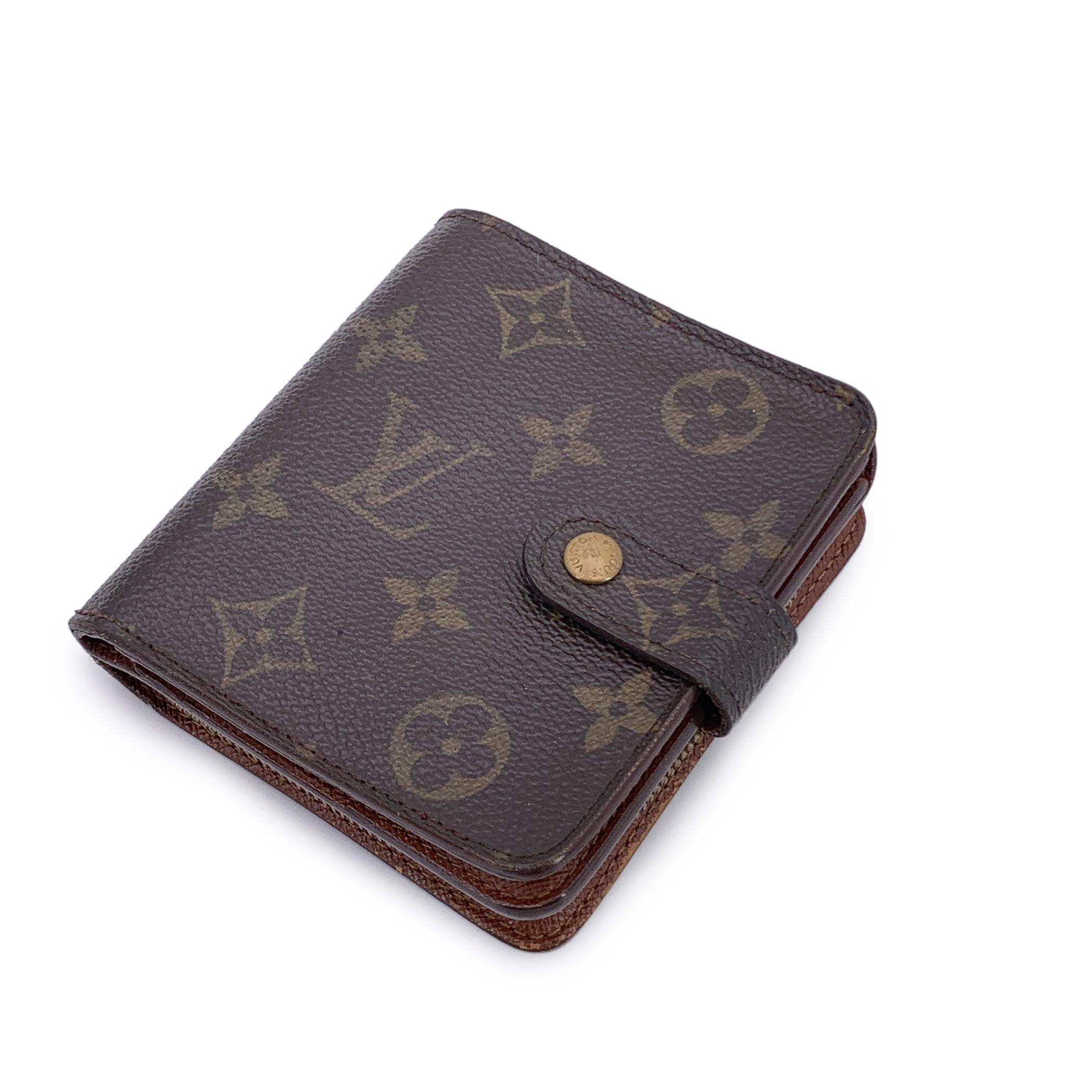 Charming in both form and function, this vintage Louis Vuitton compact wallet captures the essence of classic French design in a beautifully square-shaped silhouette. Crafted from the house's iconic brown Monogram canvas, it features a snap button