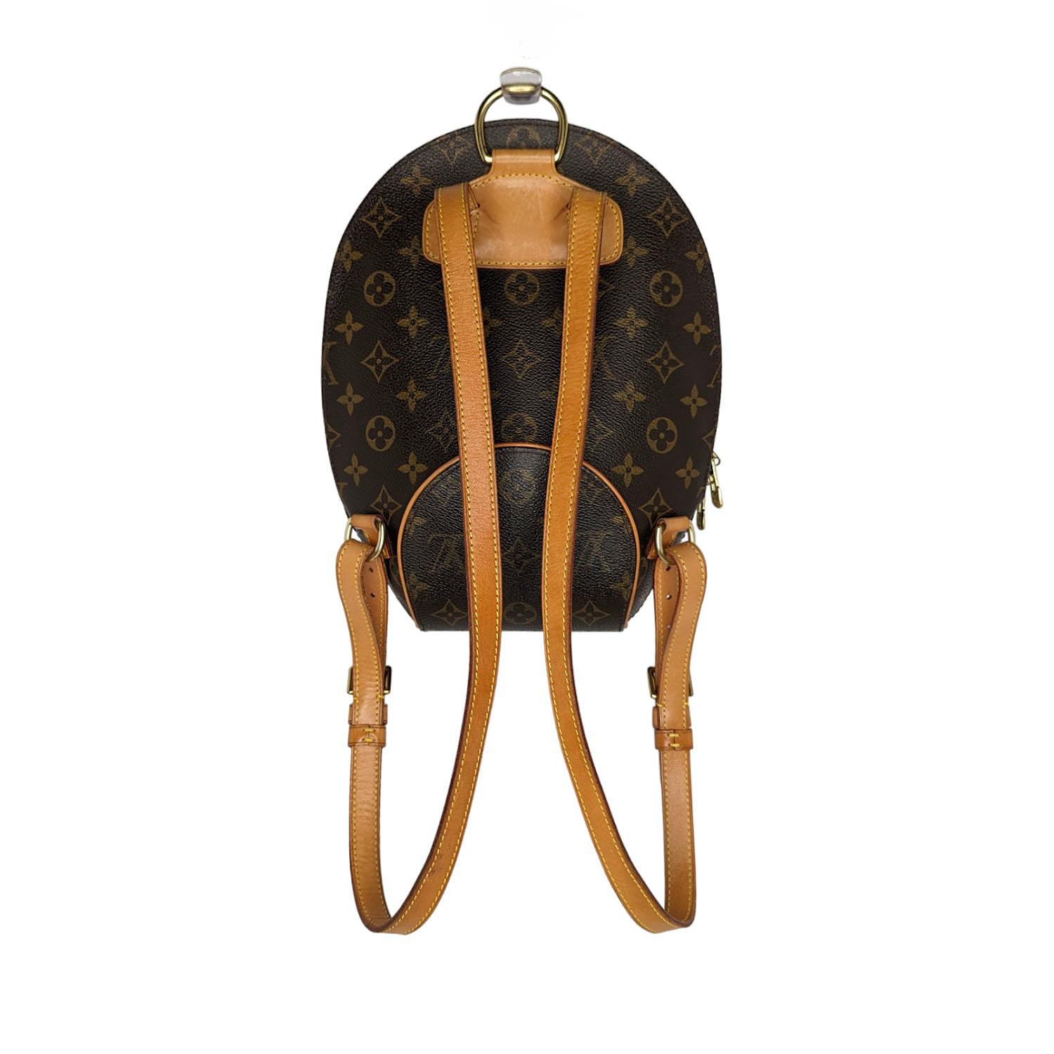 This petite backpack is crafted of classic Louis Vuitton monogram coated canvas with complimentary signature vachetta natural cowhide for structure and style. There is a brass 3/4 wrap-around zipper that opens to an interior of resistant,