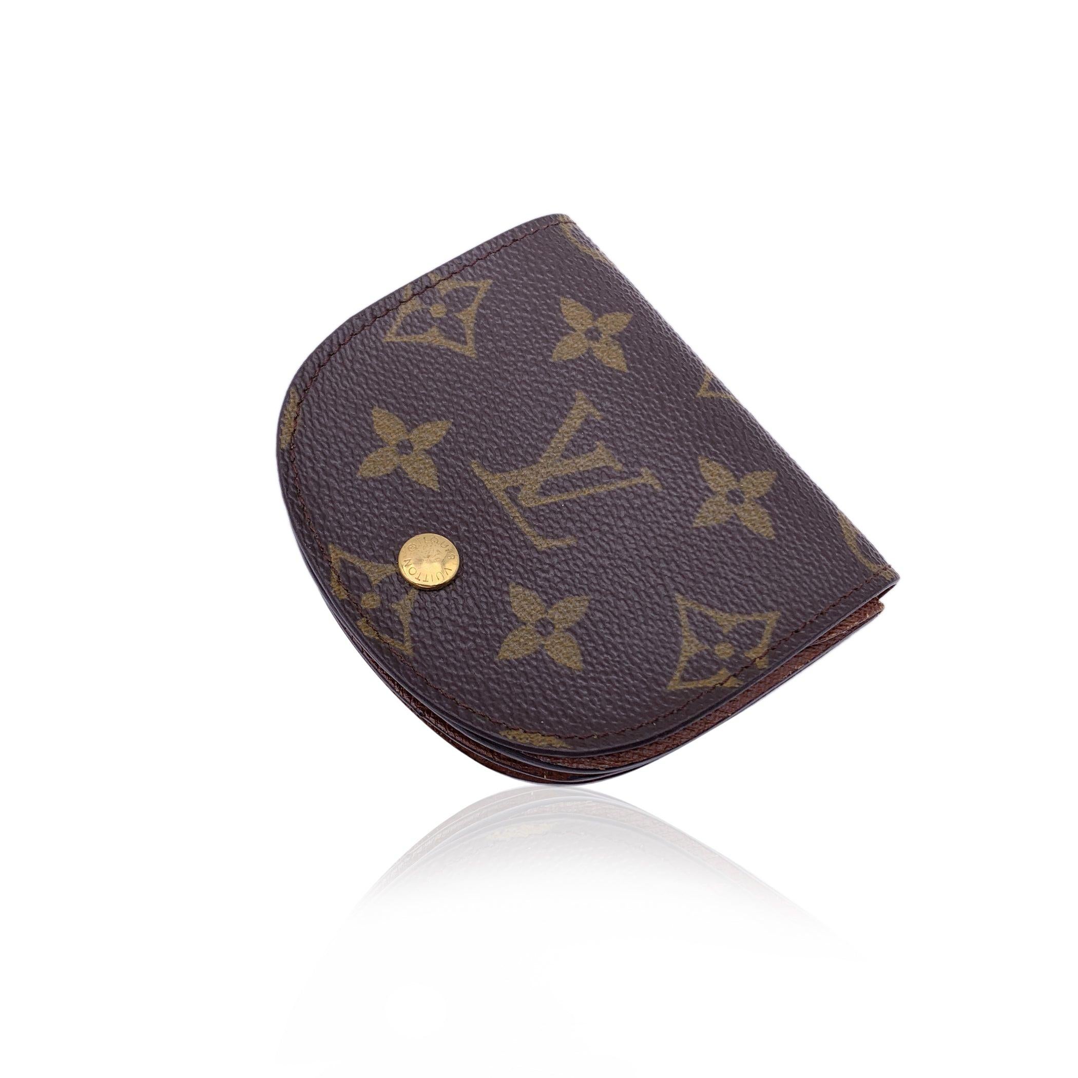 Louis Vuitton coin purse, mod. M61970. Monogram canvas. Leather lining. Flap and press stud closure. 2 compartments and 1 section with flap. 'Louis Vuitton Paris - Made in France' embossed inside. Authenticity serial number embossed inside a pocket.