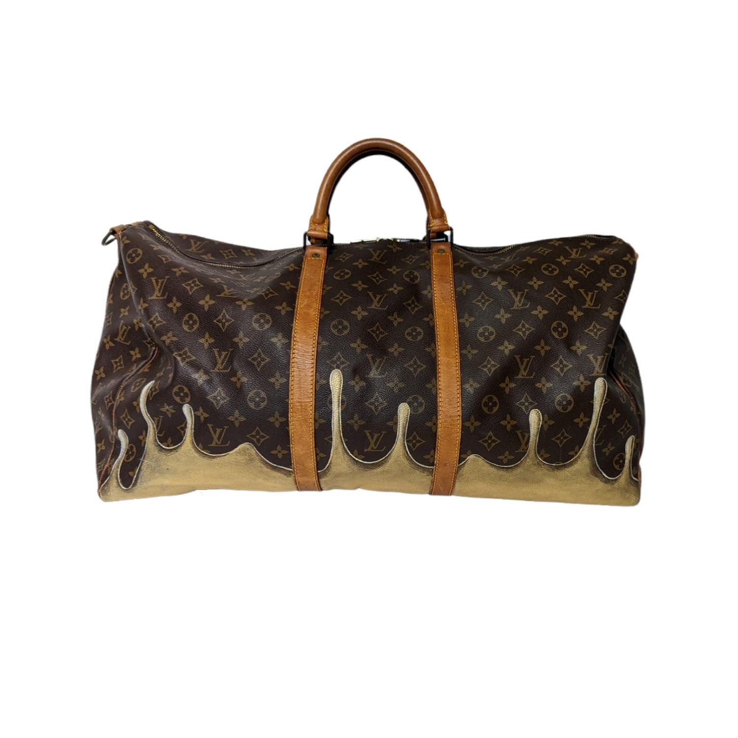Brown and tan monogram coated canvas vintage Louis Vuitton Keepall Bandoulière 60 with dripping paint graphics at front face, brass hardware, dual rolled top handles, tan Vachetta leather trim, tonal canvas lining and dual zip closures at top.