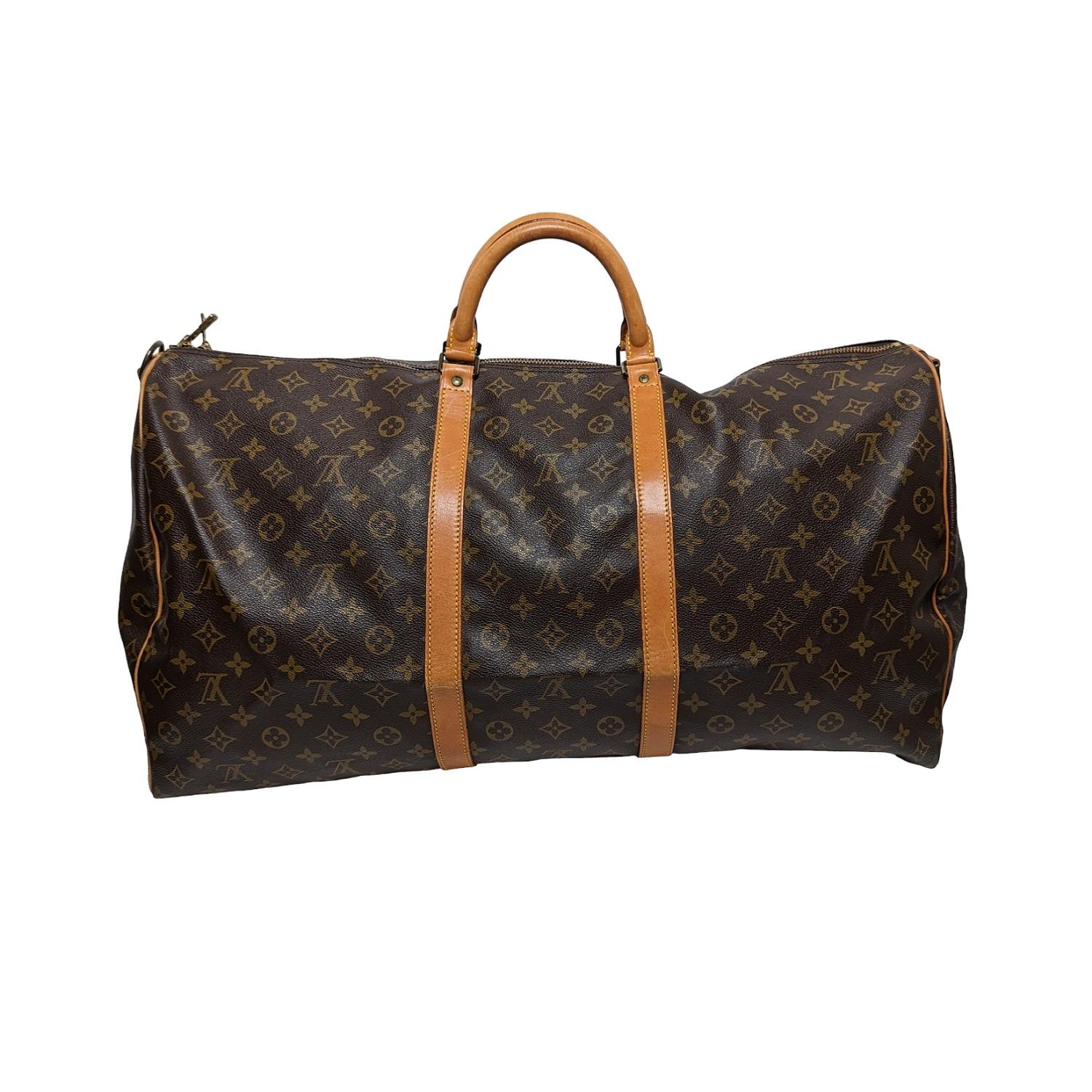 This stylish duffel is crafted of signature Louis Vuitton monogram toile canvas. This bag features vachetta cowhide leather rolled top handles, vachetta leather trim, and a detachable adjustable shoulder strap. The polished brass top zippers open to