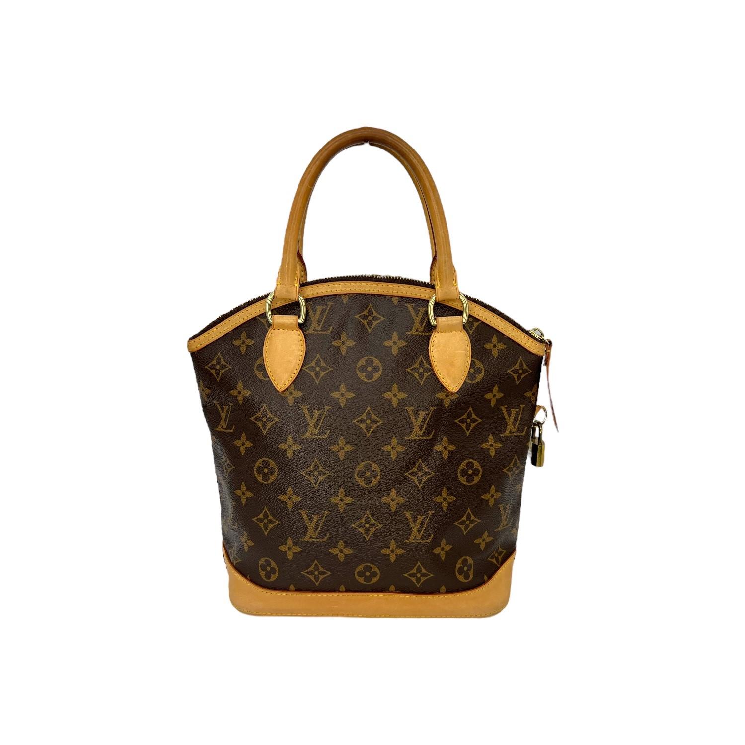 This Louis Vuitton Lockit Vertical Tote was made in the USA in 2006 and it is finely crafted of the classic Louis Vuitton Monogram coated canvas with leather trimming and gold-tone hardware features. It has rolled leather handles. It has a zipper