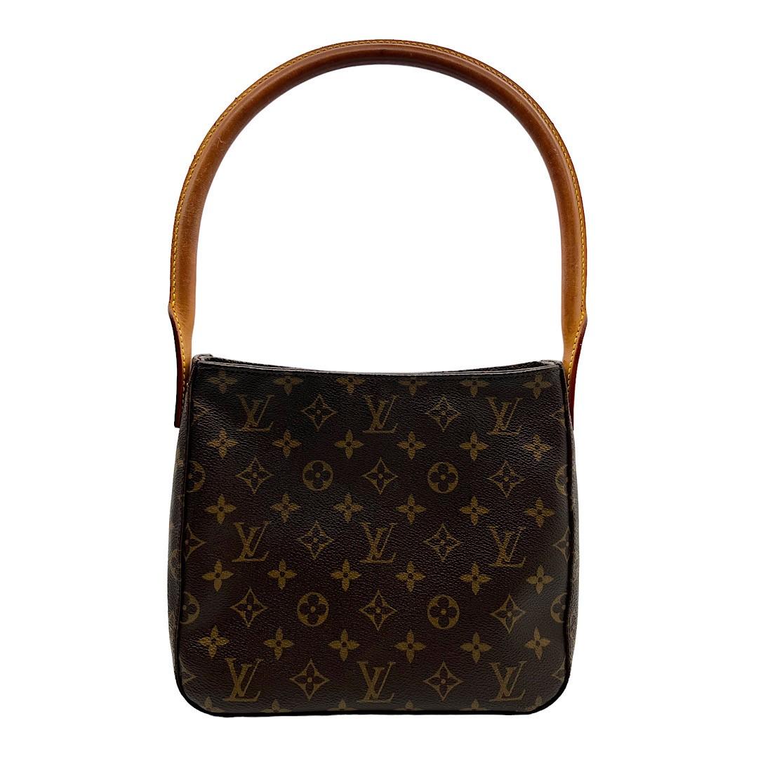 We are offering this Louis Vuitton Monogram Looping MM. Made in France in 2002, this bag is crafted of Louis Vuitton's signature LV monogram coated canvas with a leather top handle. It has a gold-tone zipper top closure that opens up to a spacious
