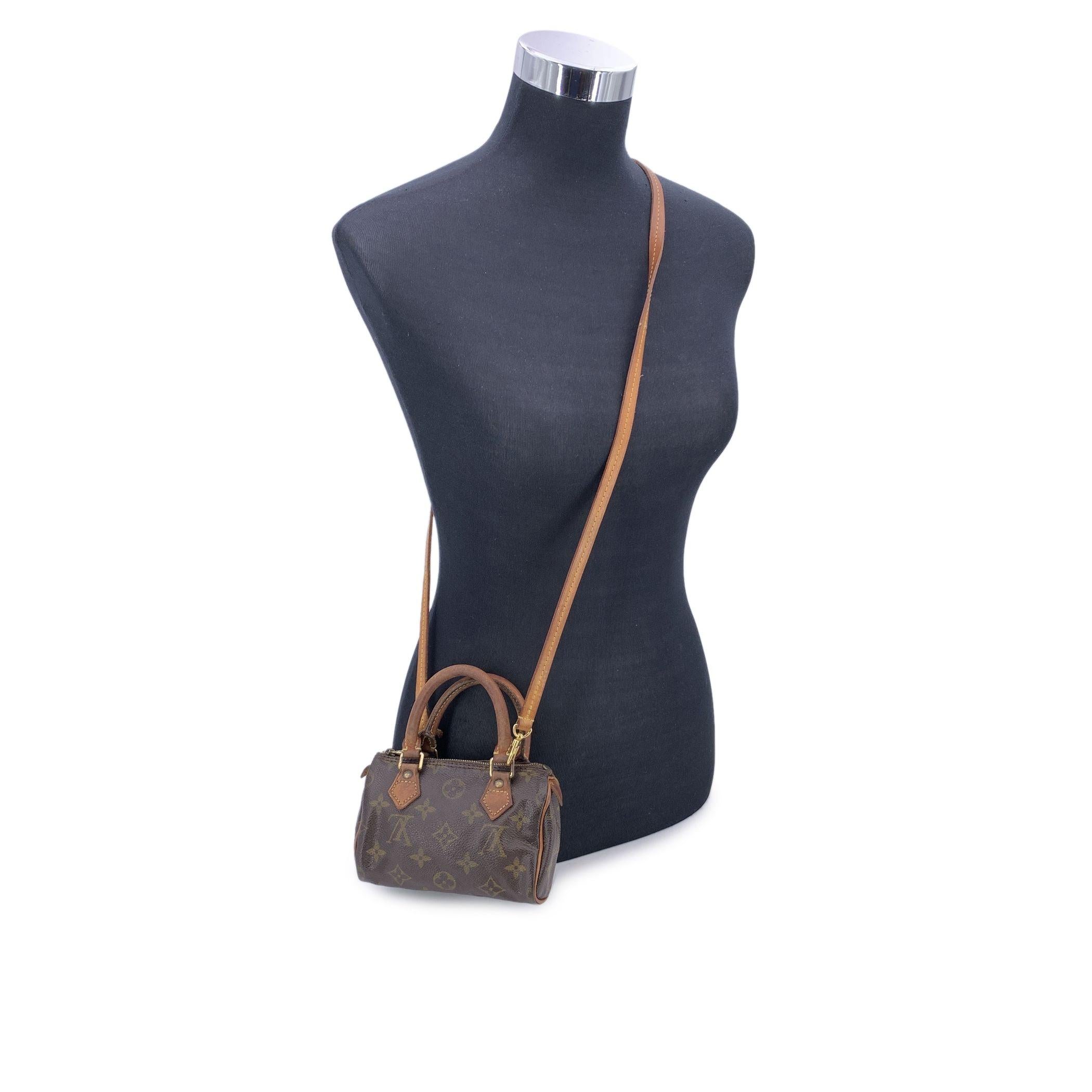 This beautiful item will come with a Certificate of Authenticity provided by Entrupy. The certificate will be provided at no further cost Step into the world of luxury with this Vintage Louis Vuitton 'Mini Sac HL/Speedy Nano' handbag, a miniature