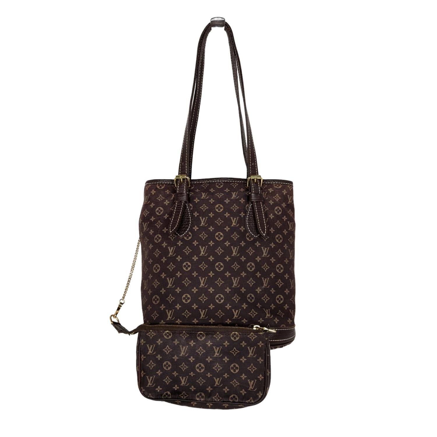 This iconic bucket shaped shoulder bag is finely crafted of the Monogram Mini Lin canvas in brown, which is supple, light and stain resistant. It is 58% cotton, 24% linen, and 18% polyamide. The trim features grained calf leather at the base and