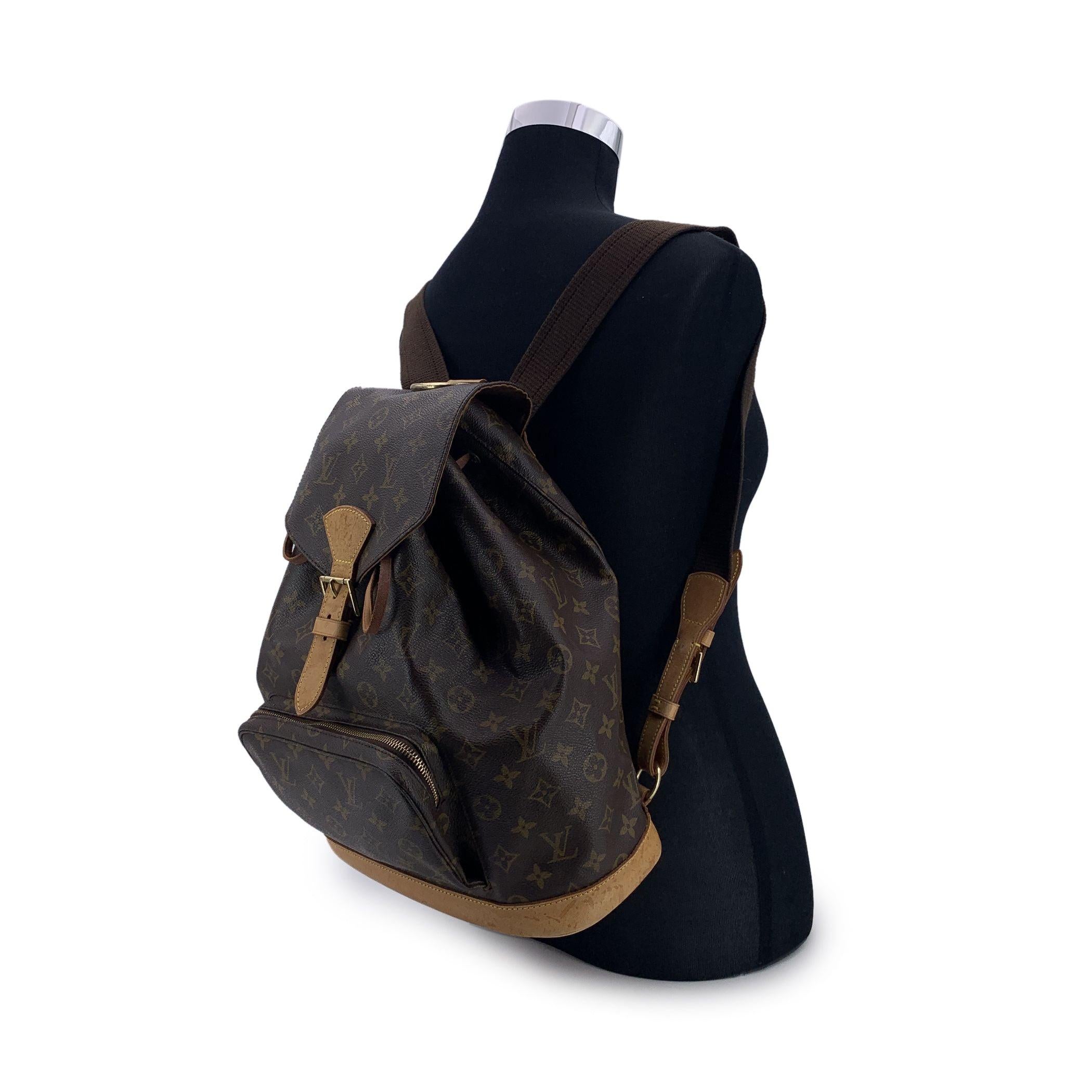 Casual yet sophisticated at the same time Louis Vuitton 'Montsouris GM' Backpack bag . Top is closed with flap with buckle closure and drawstring. 1 front zip pocket.Long and adjustable shoulder straps with gold metal hardware. Brown canvas