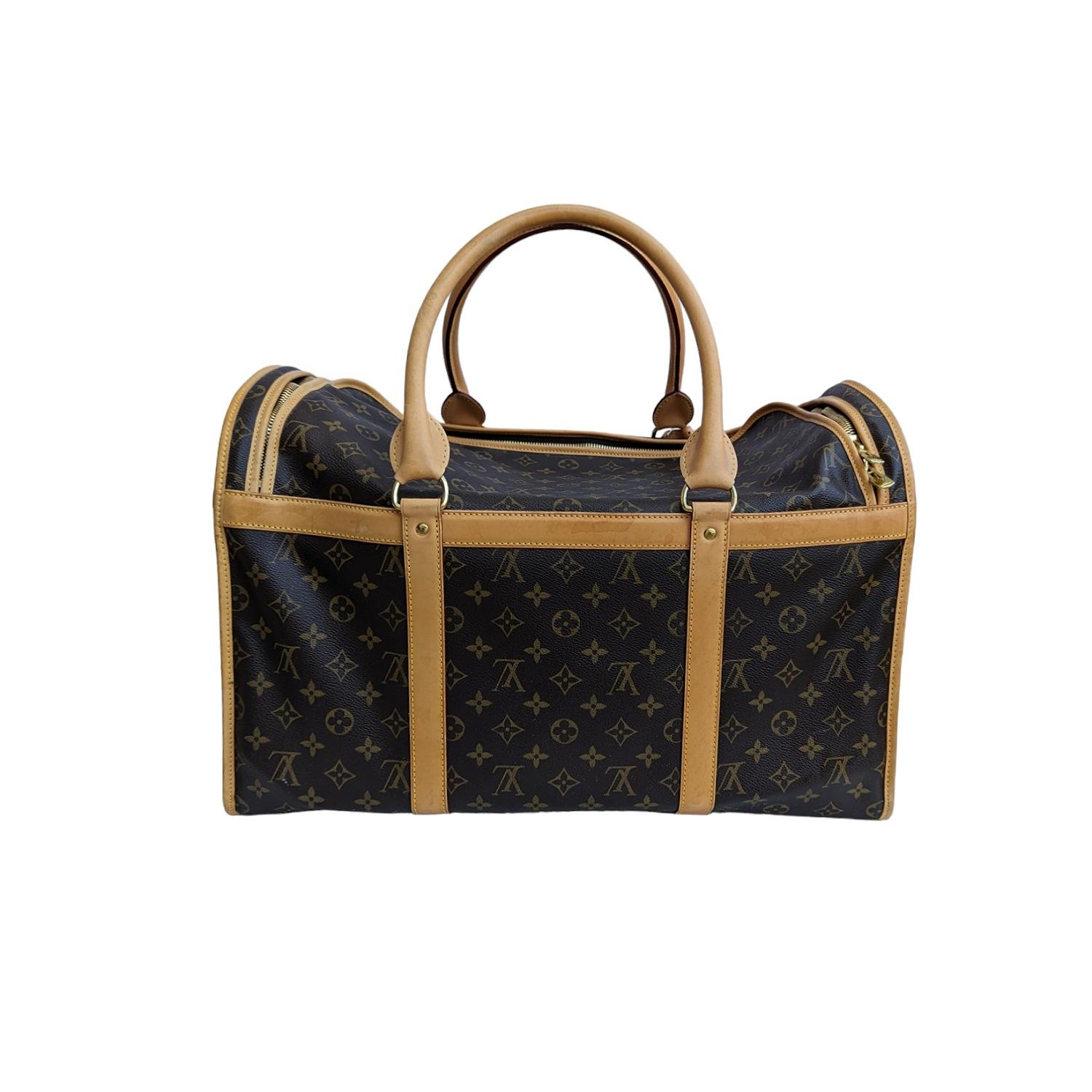 Travel in style with your posh pet with this Louis Vuitton Monogram Canvas Sac Chien 50 Dog Carrier. It features an accessible top with breathable metal side mesh with roll-up window option. It also has a double zip around closure and convenient