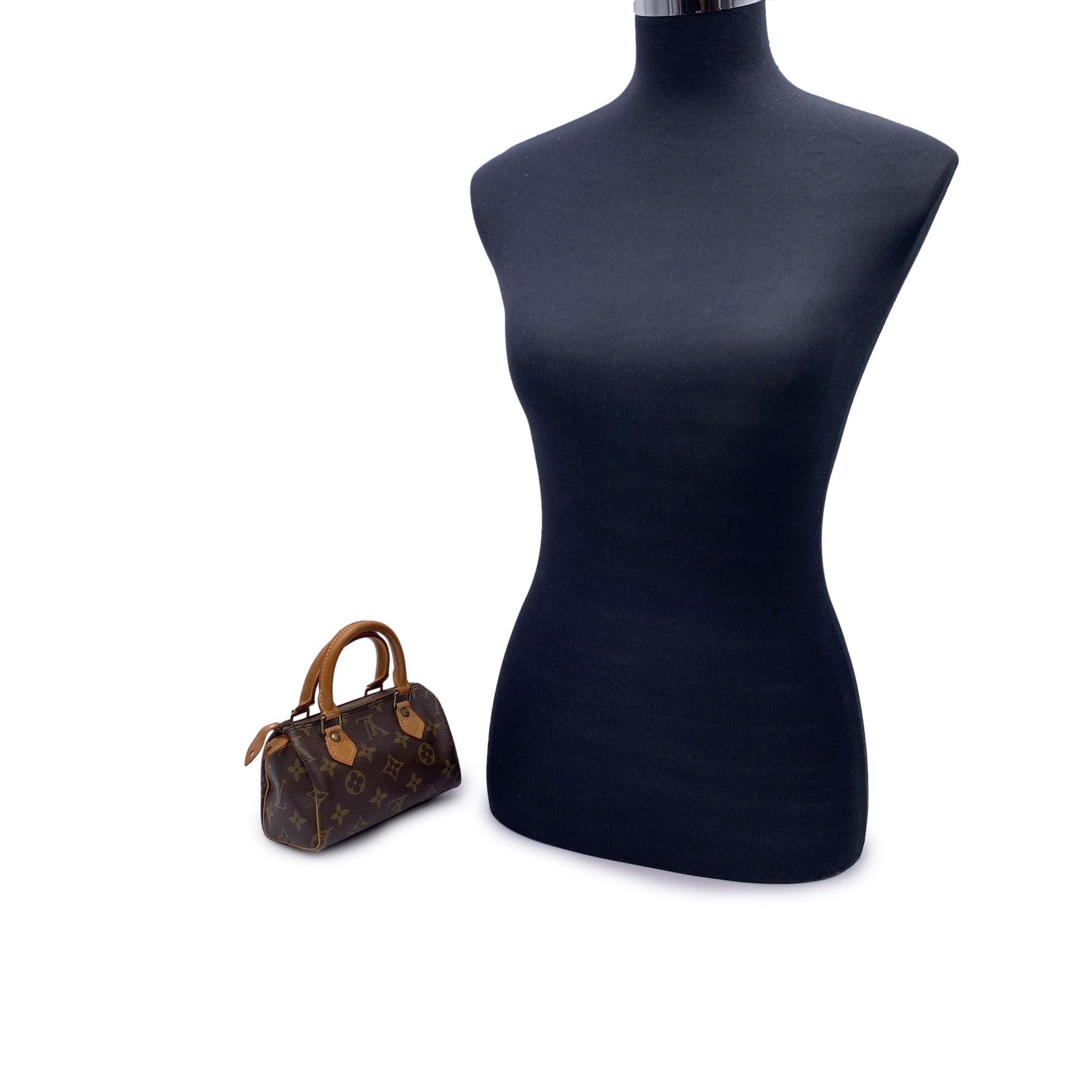 Vintage Louis Vuitton 'Mini Sac HL/ Speedy Nano' handbag.This is a miniature model of the famous Speedy bag. Rounded form, double leather handles and piping. Brown monogram canvas. Gold metal signed hardware. Upper zipper closure. Brown canvas