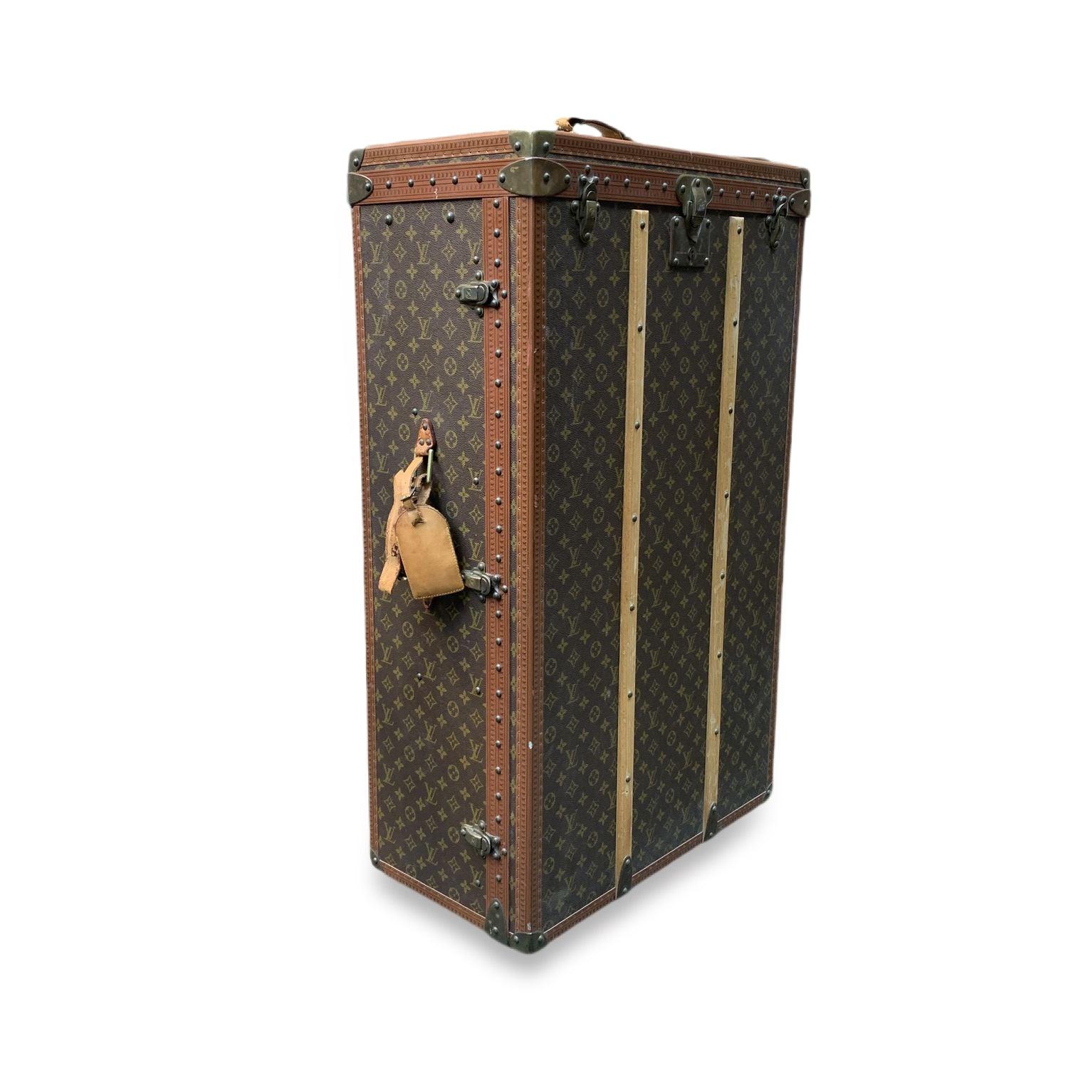 Rare vintage travel wardrobe trunk by Louis Vuitton, form the 1970s. It is crafted in the timeless monogram canvas with LV leather trim on the borders. Double handles. Leather ID tag still attached. Louis Vuitton main lock reinforced with two