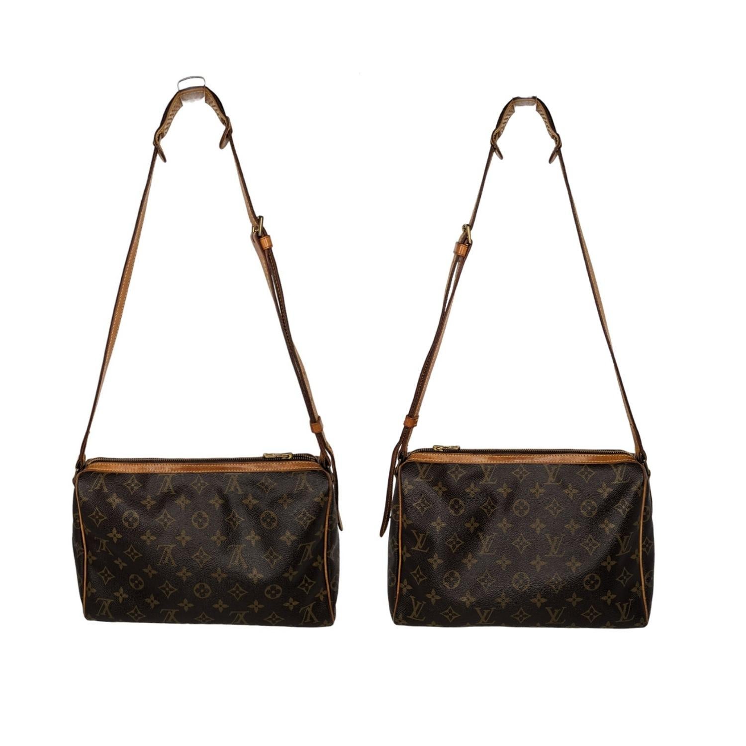 This shoulder bag is crafted of classic Louis Vuitton monogram coated canvas. The bag features signature vachetta leather piping trim, an adjustable crossbody strap and a brass top zipper that opens to a terra cotta cross-grain leather interior with