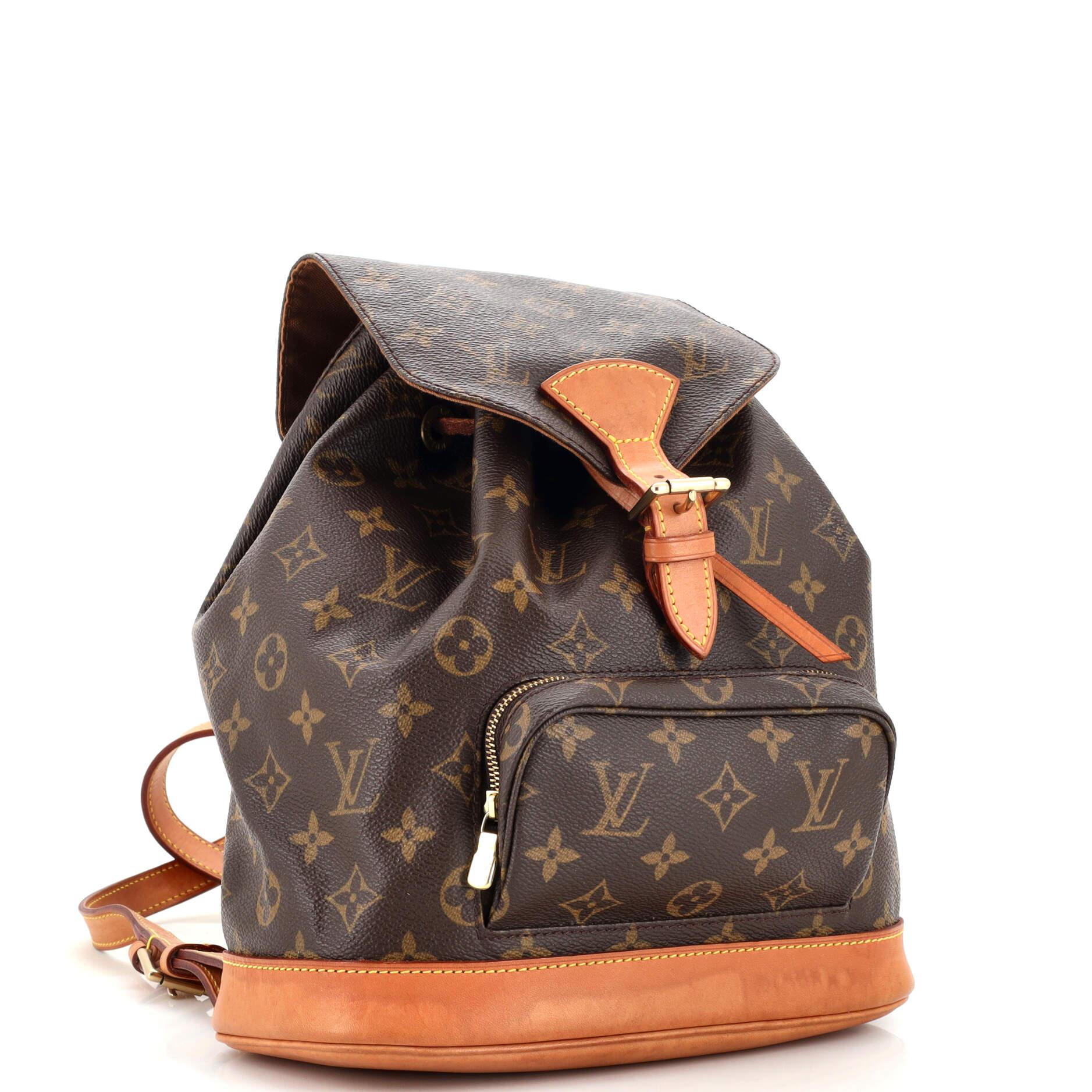Condition: Good. Moderate odor in interior. Creasing on exterior, moderate watermarks and darkening on leather trims, straps and flap closure. Pilling underneath drawstring, scratches and tarnish on hardware.
Accessories: No