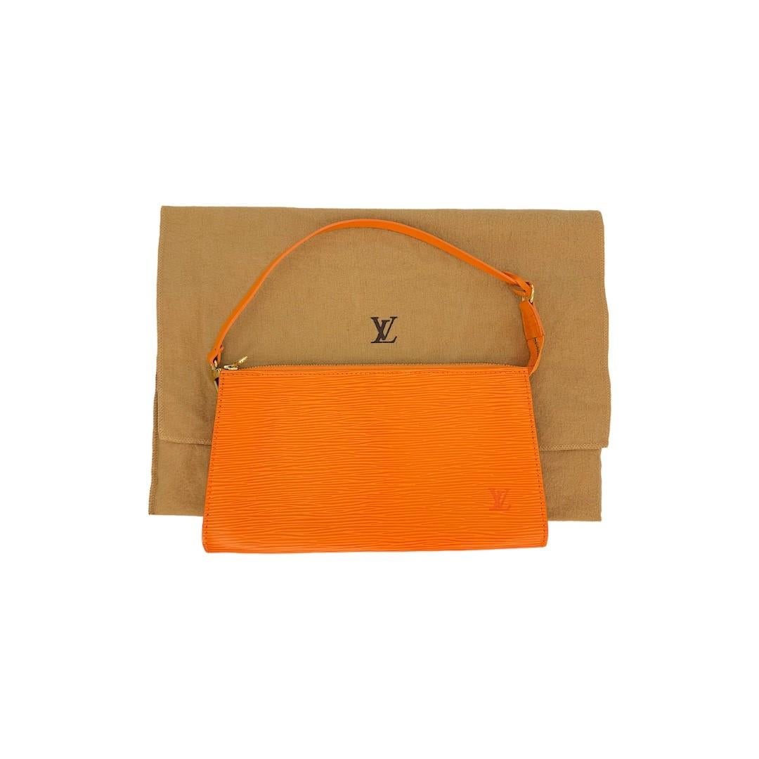 This Louis Vuitton handbag was made in France in 2004, and it is finely crafted of an Orange Epi Leather exterior with gold-tone hardware. It has a flat leather top handle. It has a zipper closure that opens up to a spacious orange Alcantara