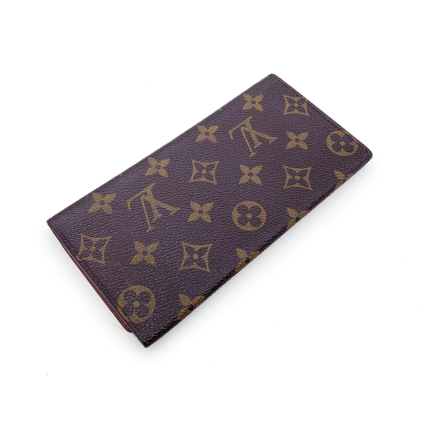 Vintage Louis Vuitton brown monogram canvas Porte Yen 3 Long Bill Wallet. Flap closure. Leather lining. 1 main compartments inside with 3 small open slots. 1 open pocket under the flap. 'LOUIS VUITTON Paris - made in Spain' embossed inside.