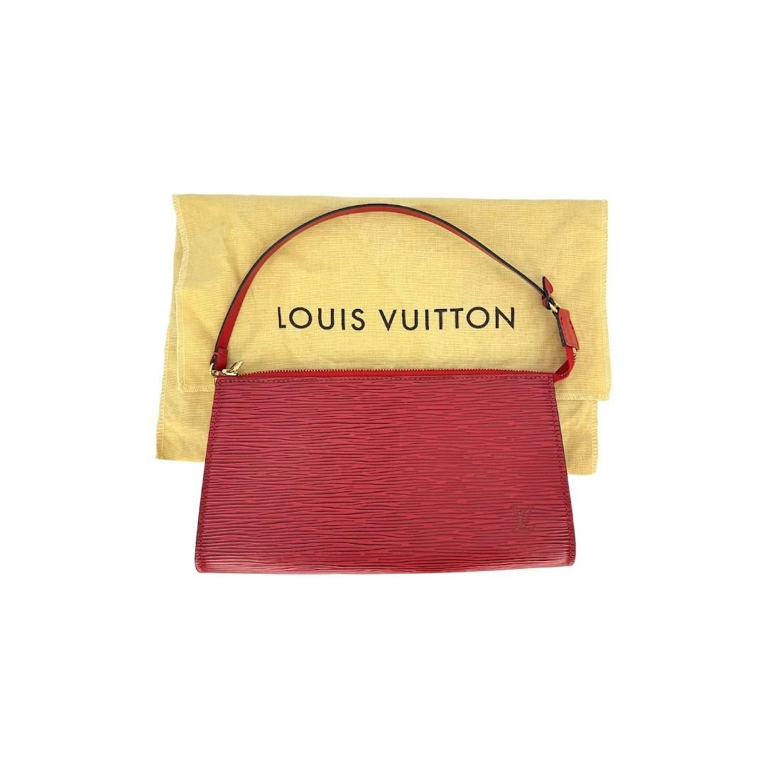 This Louis Vuitton handbag was made in France in 2002, and it is finely crafted of a Red Epi Leather exterior with gold-tone hardware. It has a flat leather top handle. It has a zipper closure that opens up to a spacious red Alcantara interior. This