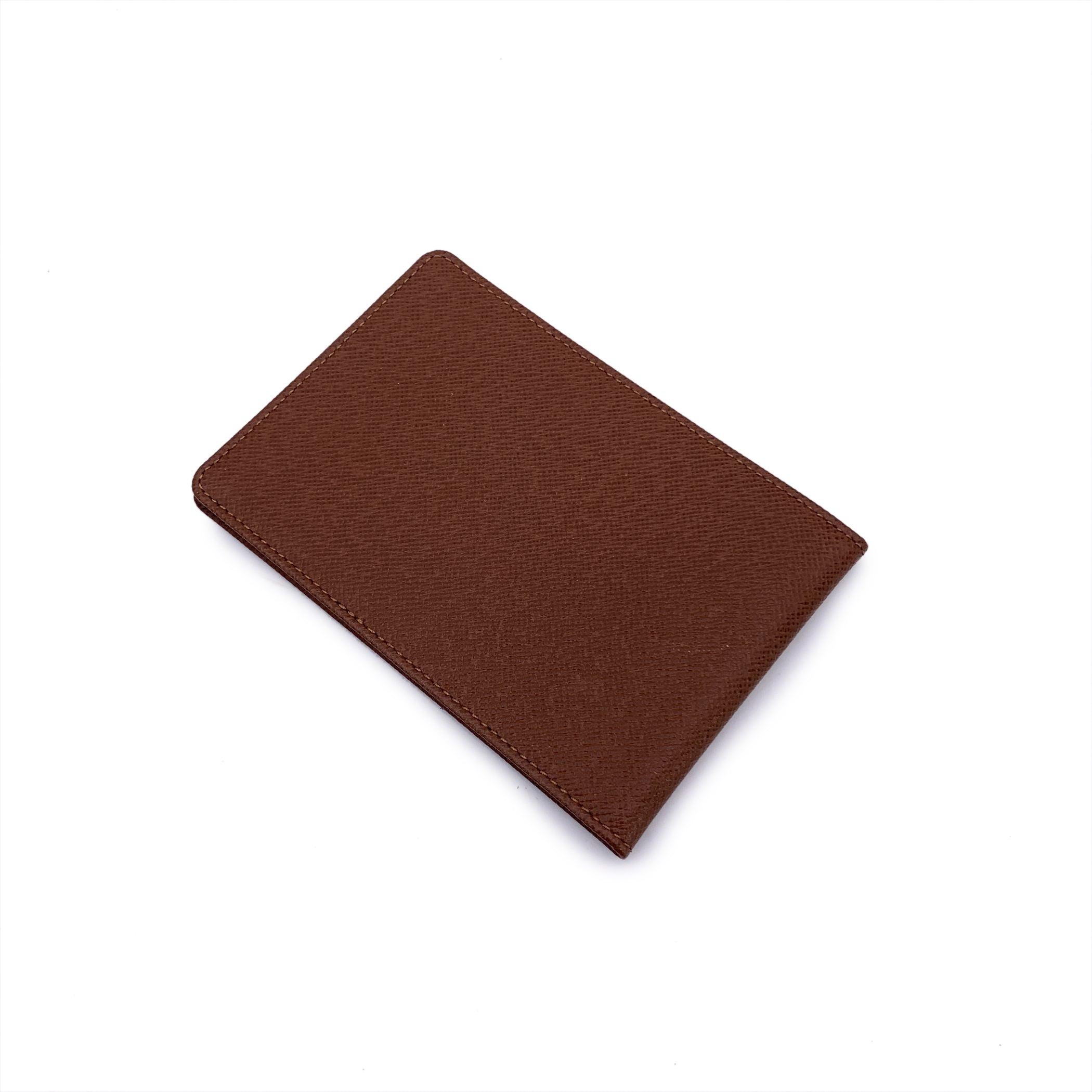 Step into the world of luxury with the Vintage Louis Vuitton Tan Taiga Leather Bifold ID Credit Card Photo Holder Wallet. Crafted in France, this timeless wallet is made from Louis Vuitton's signature Taiga leather, offering both elegance and