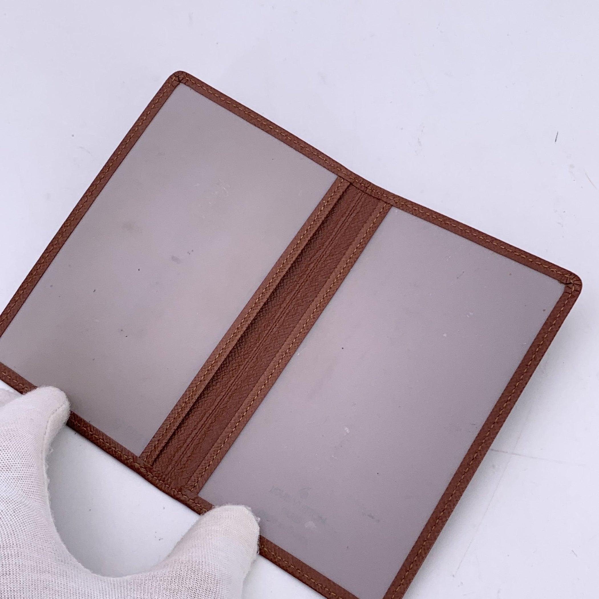 Step into the world of luxury with the Vintage Louis Vuitton Tan Taiga Leather Bifold ID Document holder Photo Holder Wallet. Crafted in France, this timeless wallet is made from Louis Vuitton's signature Taiga leather, offering both elegance and