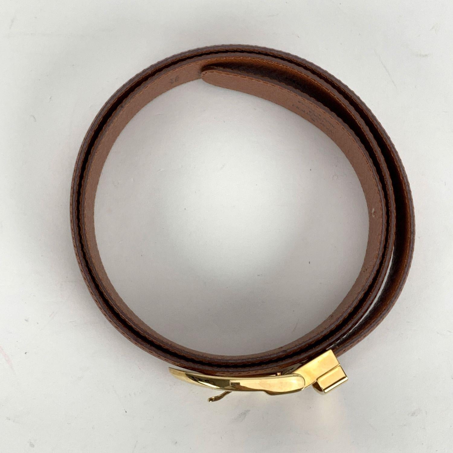 Louis Vuitton tan Taiga leather unisex Classique belt. Gold metal buckle. Width: 1.25 inches - 3 cm. 'Louis Vuitton Paris - Made in France' embossed on the reverse of the belt, serial number engraved on the reverse of the belt. 5 holes adjustment.