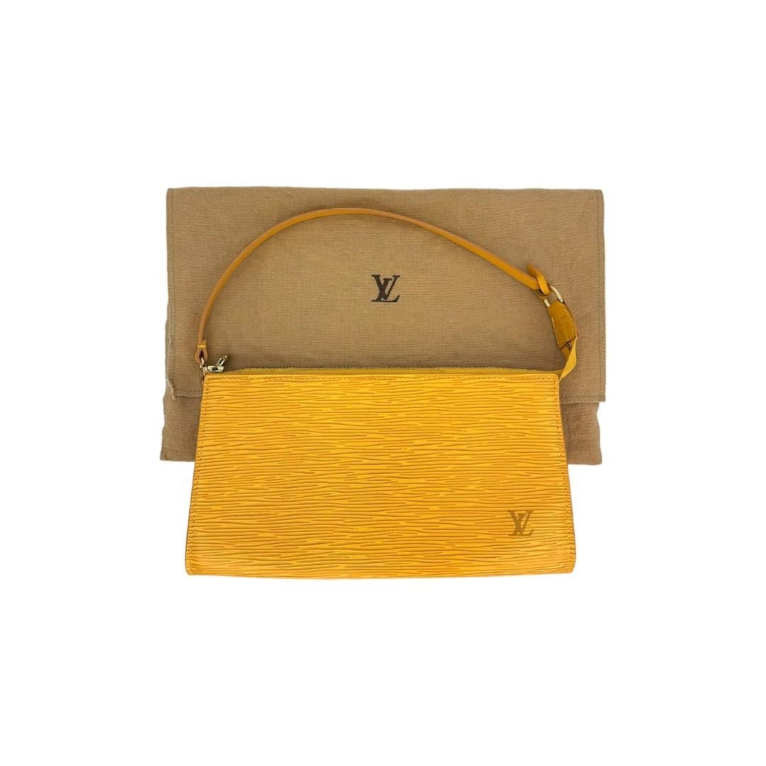 This Louis Vuitton handbag was made in France in 2002, and it is finely crafted of a Tassil Yellow Epi Leather exterior with Gold-Tone Hardware. It has a flat leather top handle. It has a zipper closure that opens up to a spacious purple Alcantara