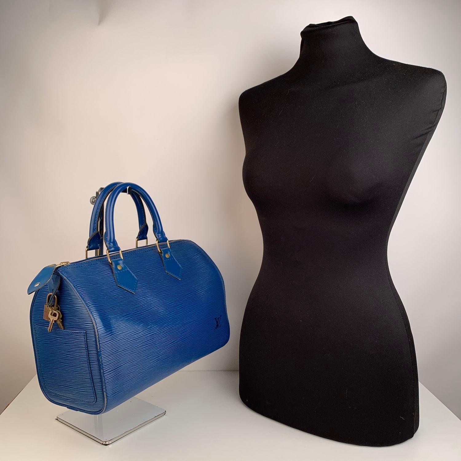 We offer Certificate of Authenticity provided by Entrupy for this item at no further cost.

Gorgeous Louis Vuitton Speedy in textured toledo blue epi leather. It has the classic Speedy 25 size and shape. The bag is accented with gold hardware and