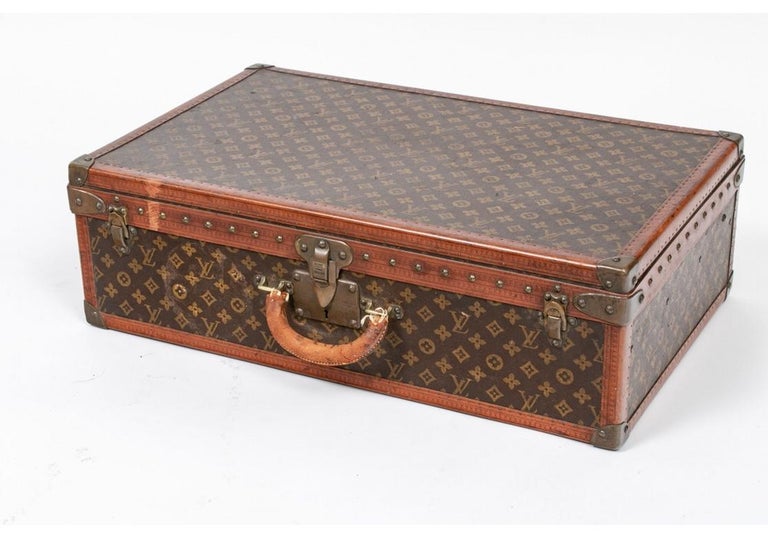 Sold at Auction: Louis Vuitton, A vintage travellers suitcase, leather and faux  leather. (D:53 x W:76 x H:18 cm)